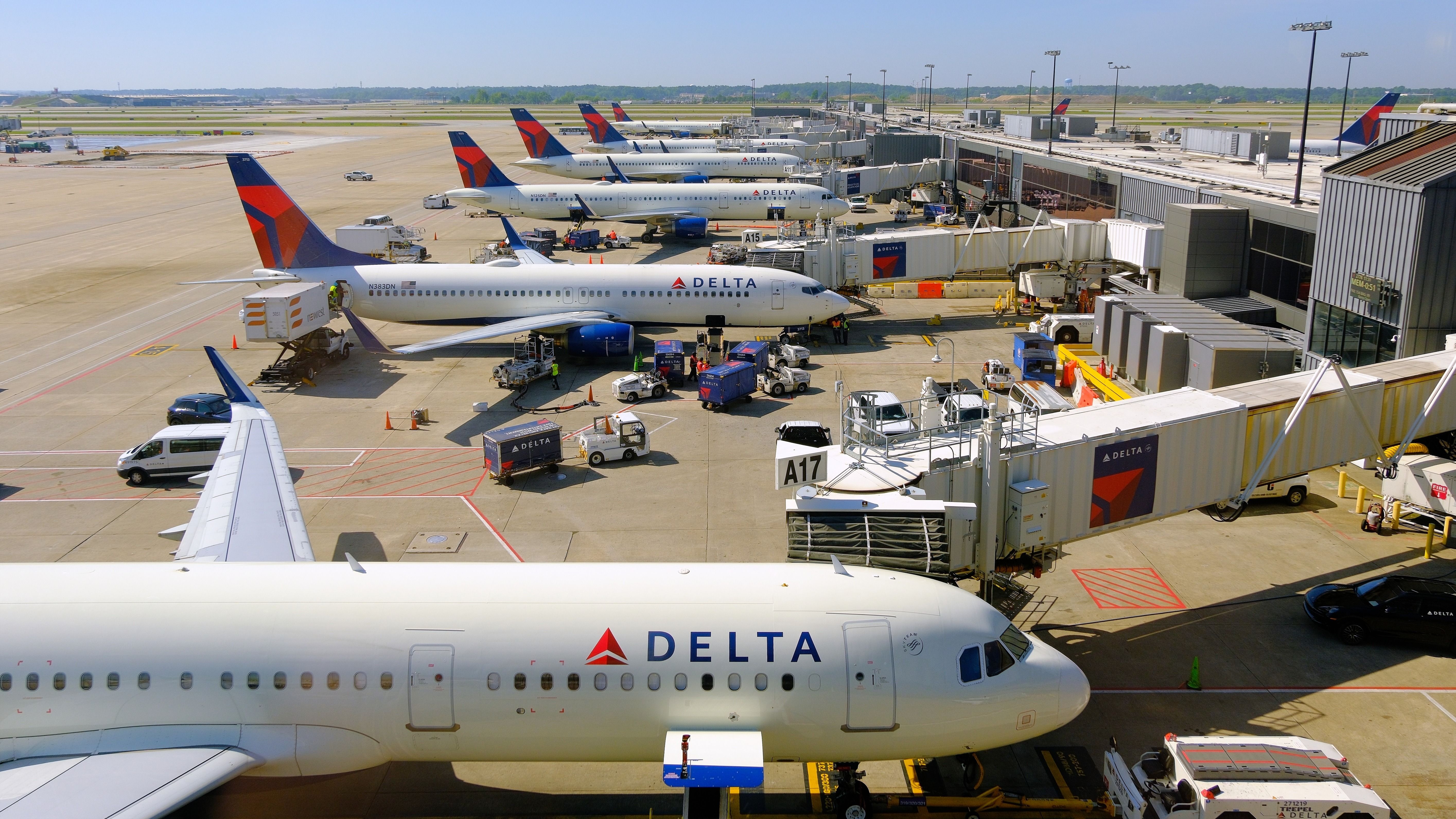 Delta Air Lines planes parked at the gates at ATL shutterstock_2305806895