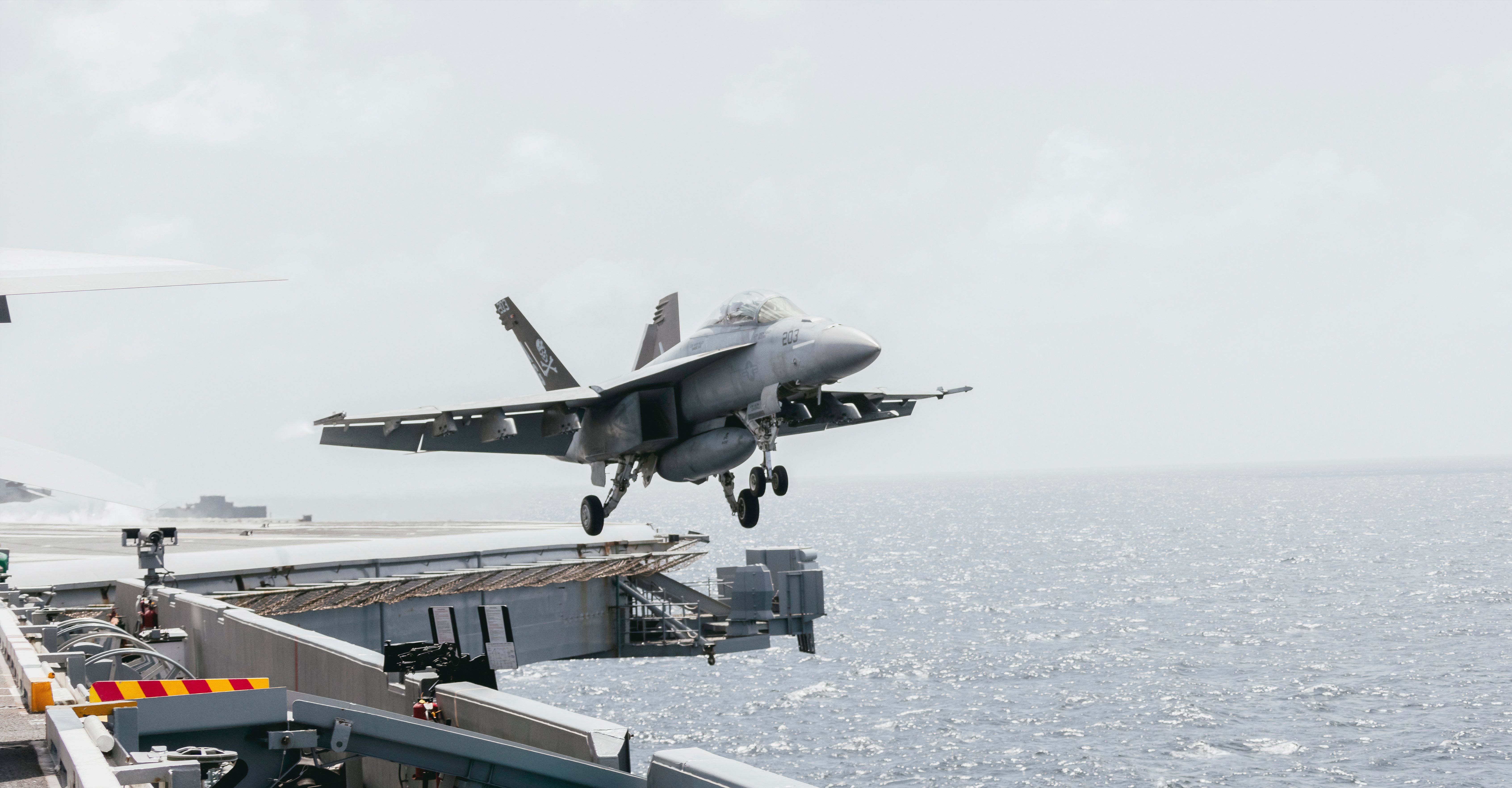 FA-18 Super Hornet taking off from an aircraft carrier.