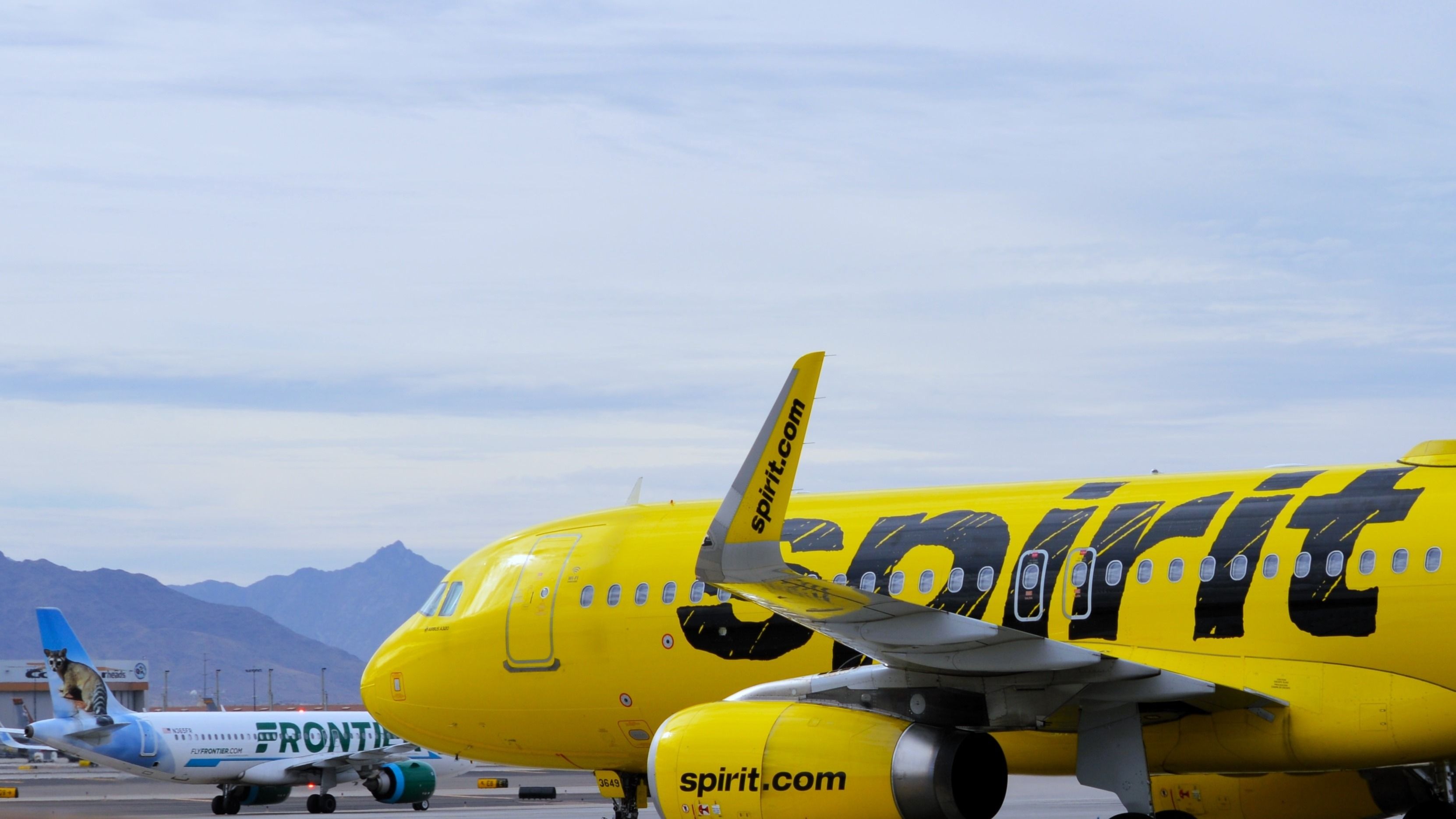 Frontier Airlines and Spirit Airlines aircraft at PHX shutterstock_2402735225