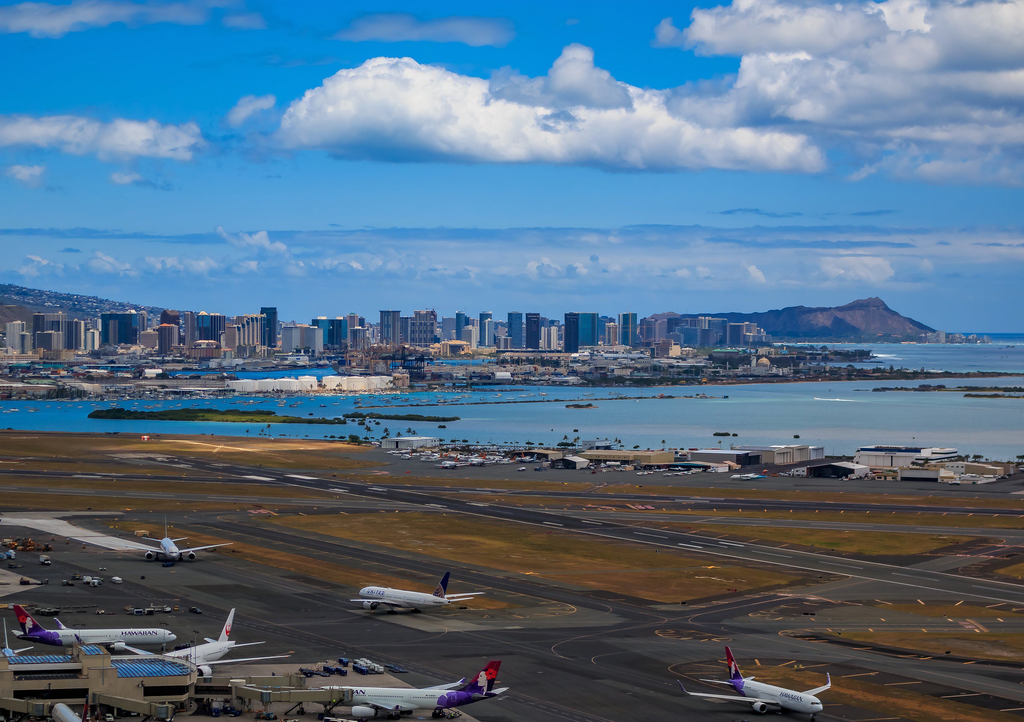 Aerial view of downtown Honolulu, Diamond Head and airplanes on the field of Daniel K. Inouye International Airport (HNL), Honolulu International Airport