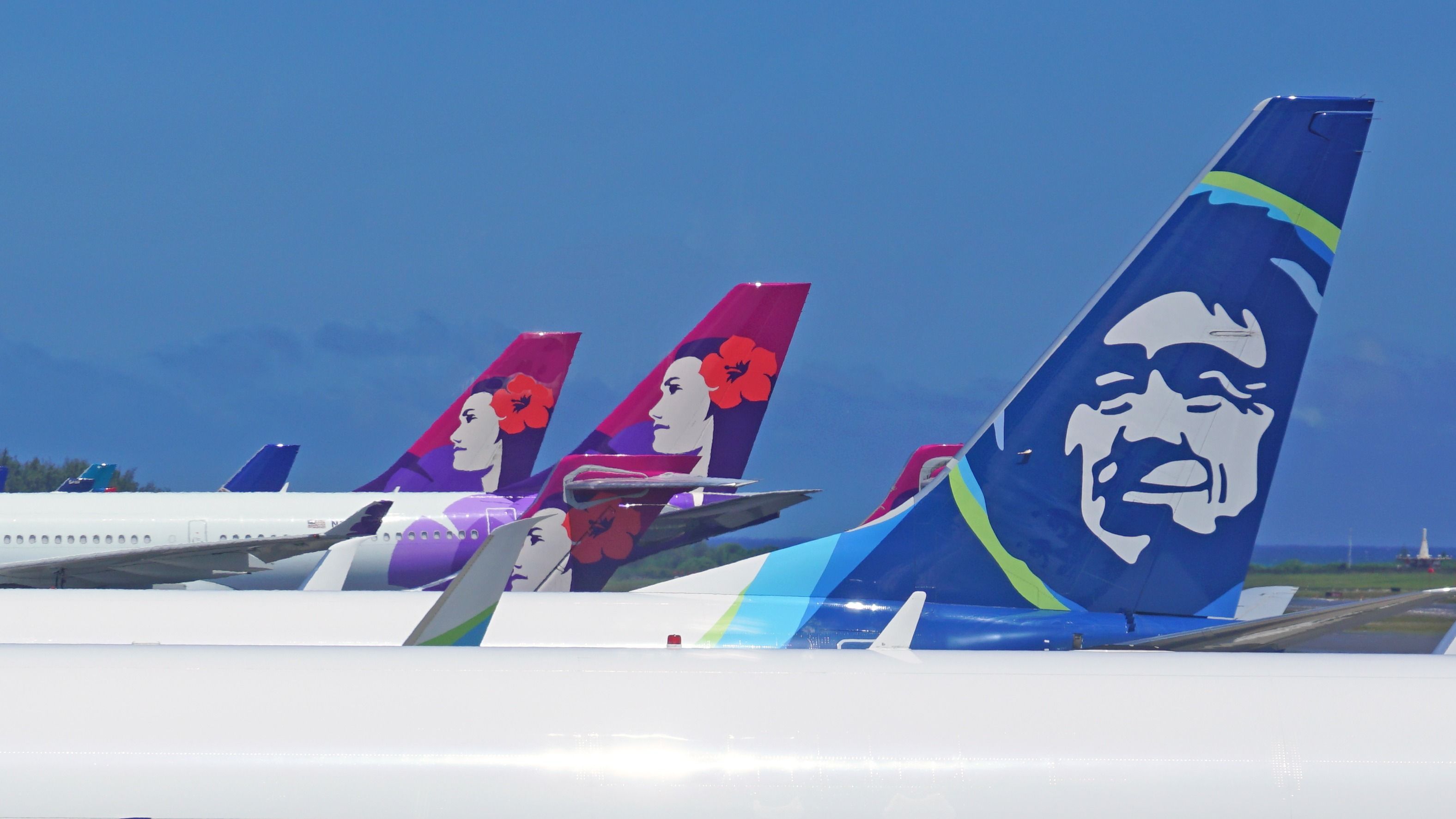 Alaska Airlines and Hawaiian Airlines tails.