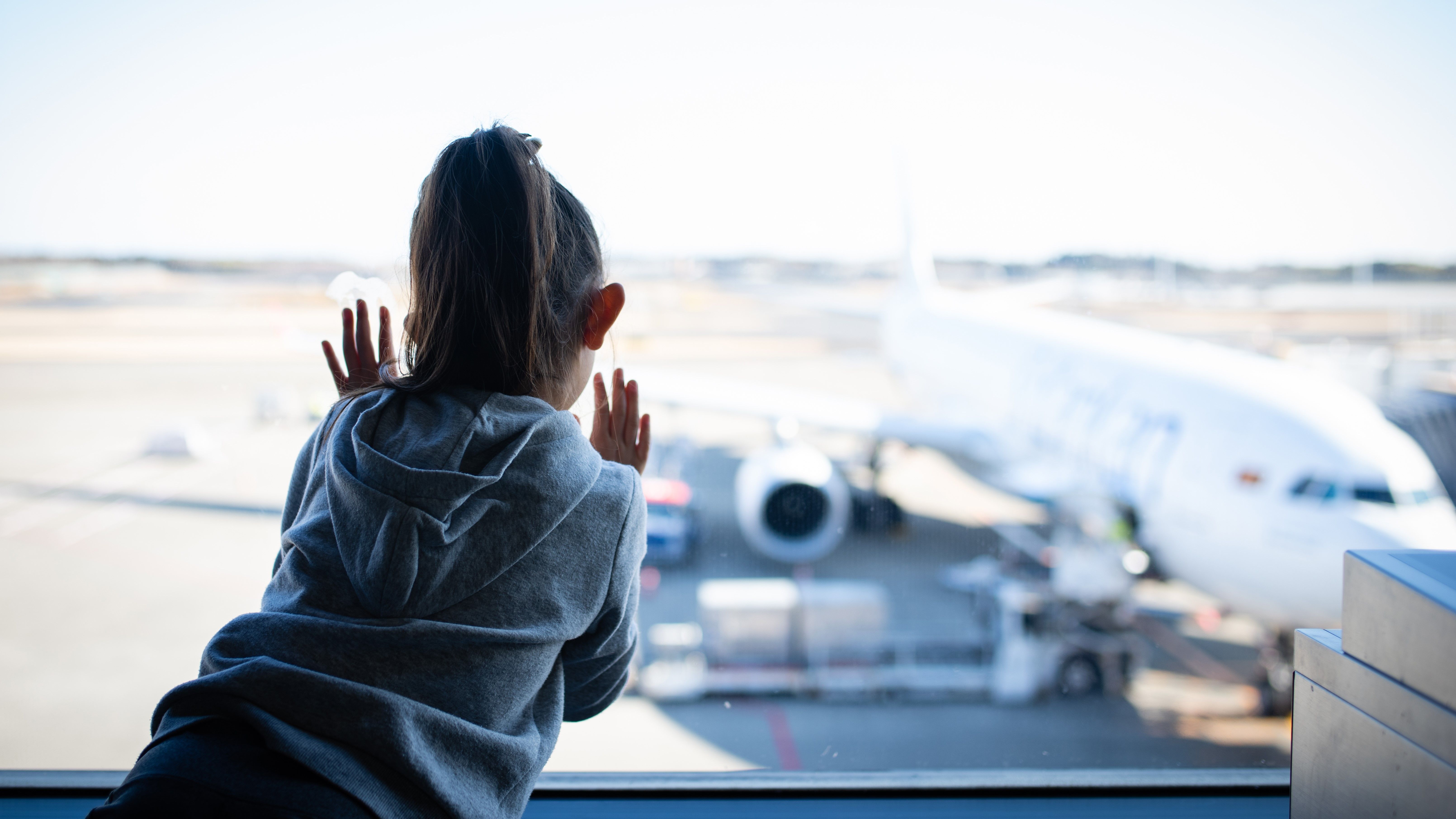 Young Passenger Looking At SriLankan Airlines Plane