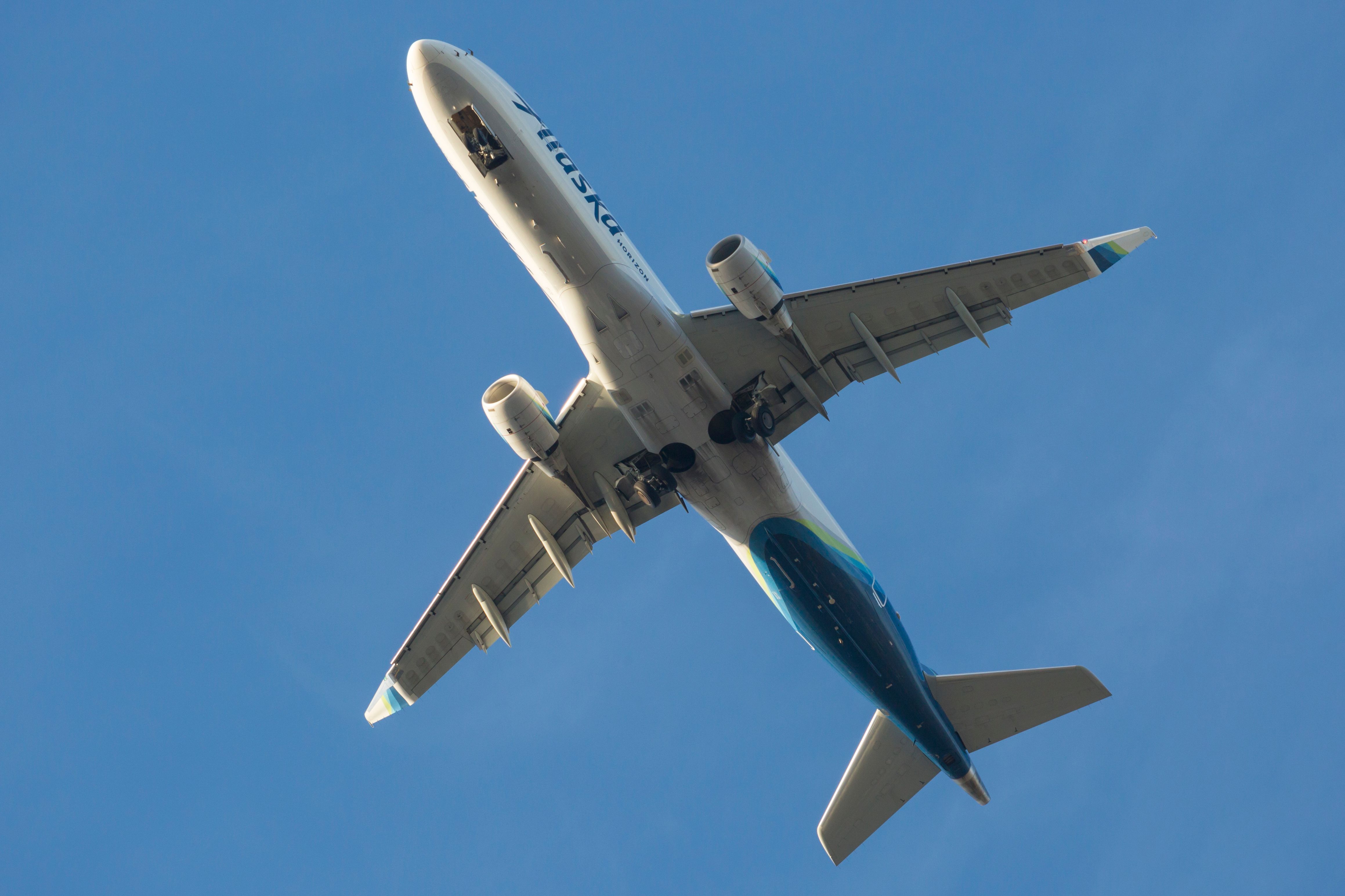 An Embraer E175 of Alaska Airlines' Horizon Air flies over Boeing Field after taking off from SEATAC.