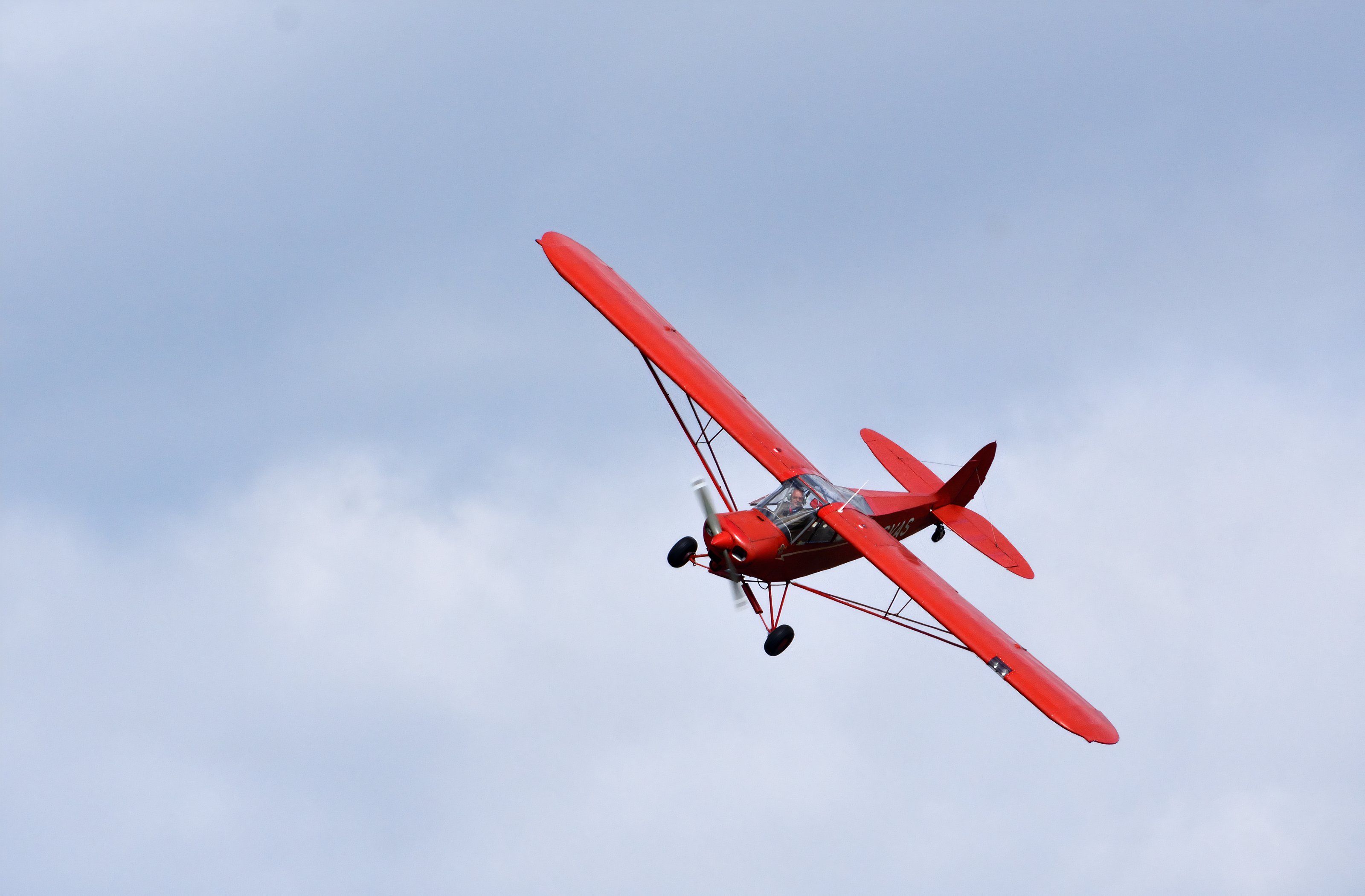 Vintage 1961 Piper Super Cub in flight close up.