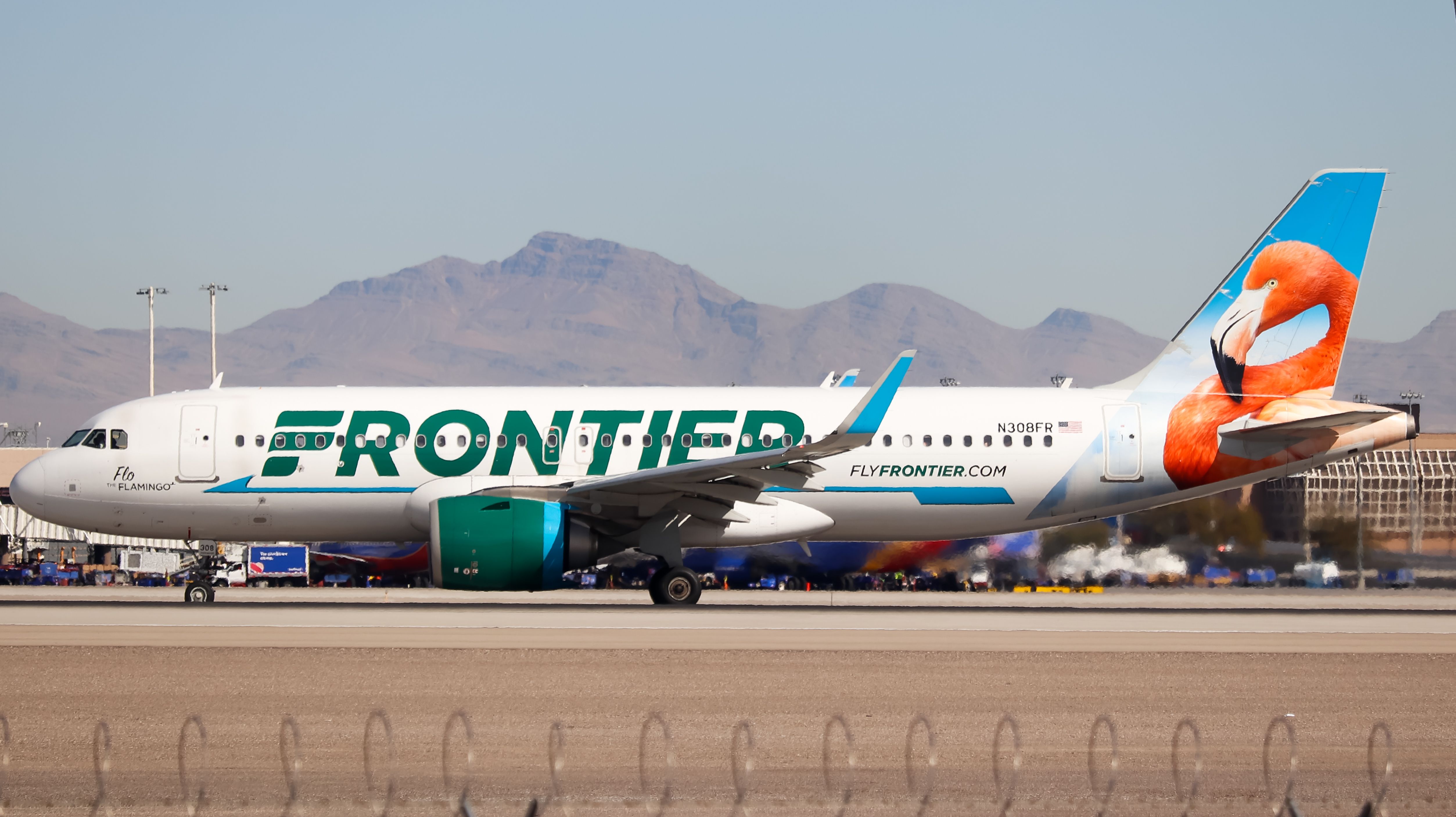 A Frontier Airlines Airbus A320 standing on the taxiway