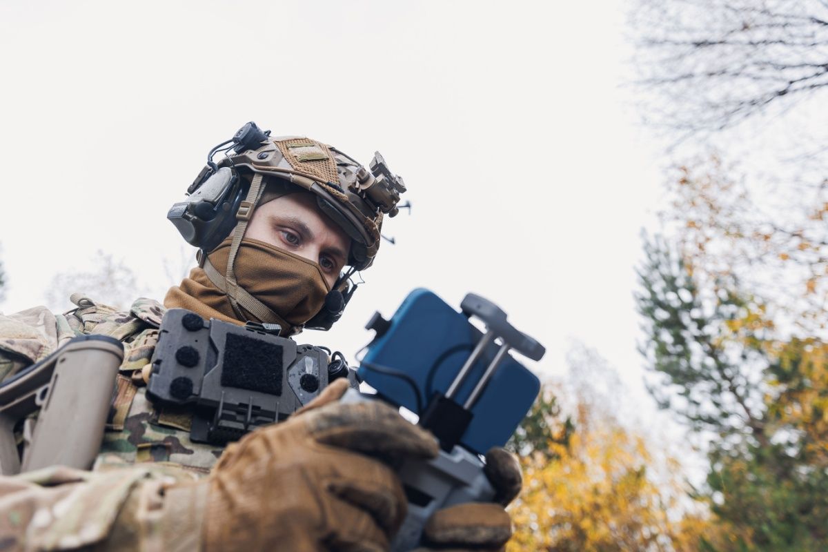 Military soldier controls drone for reconnaissance operation of enemy positions.