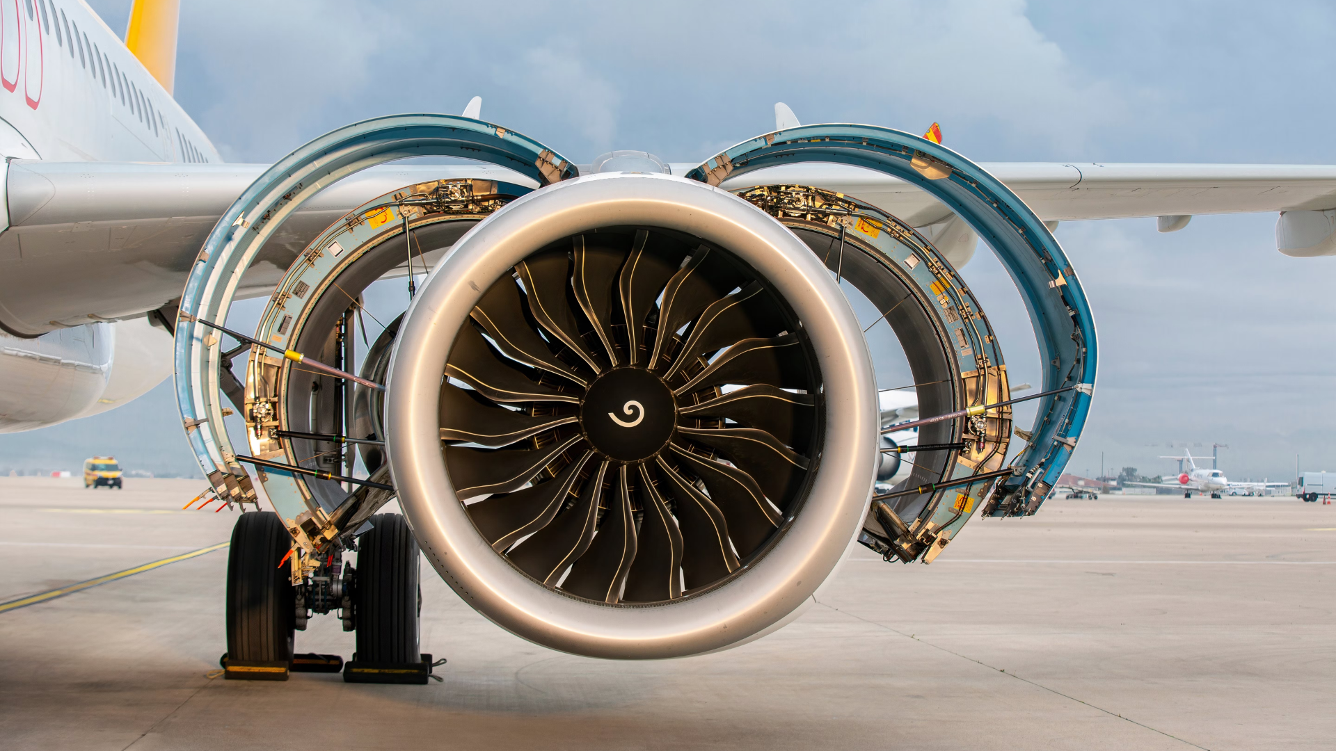 Aircraft parked with open jet engine hatches.