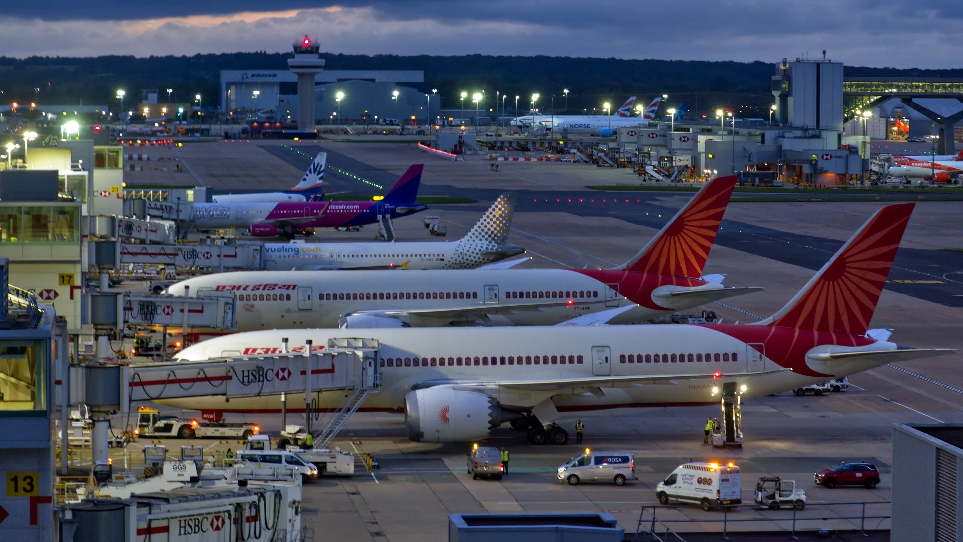 Air India planes park in dim light at London Gatwick Airport