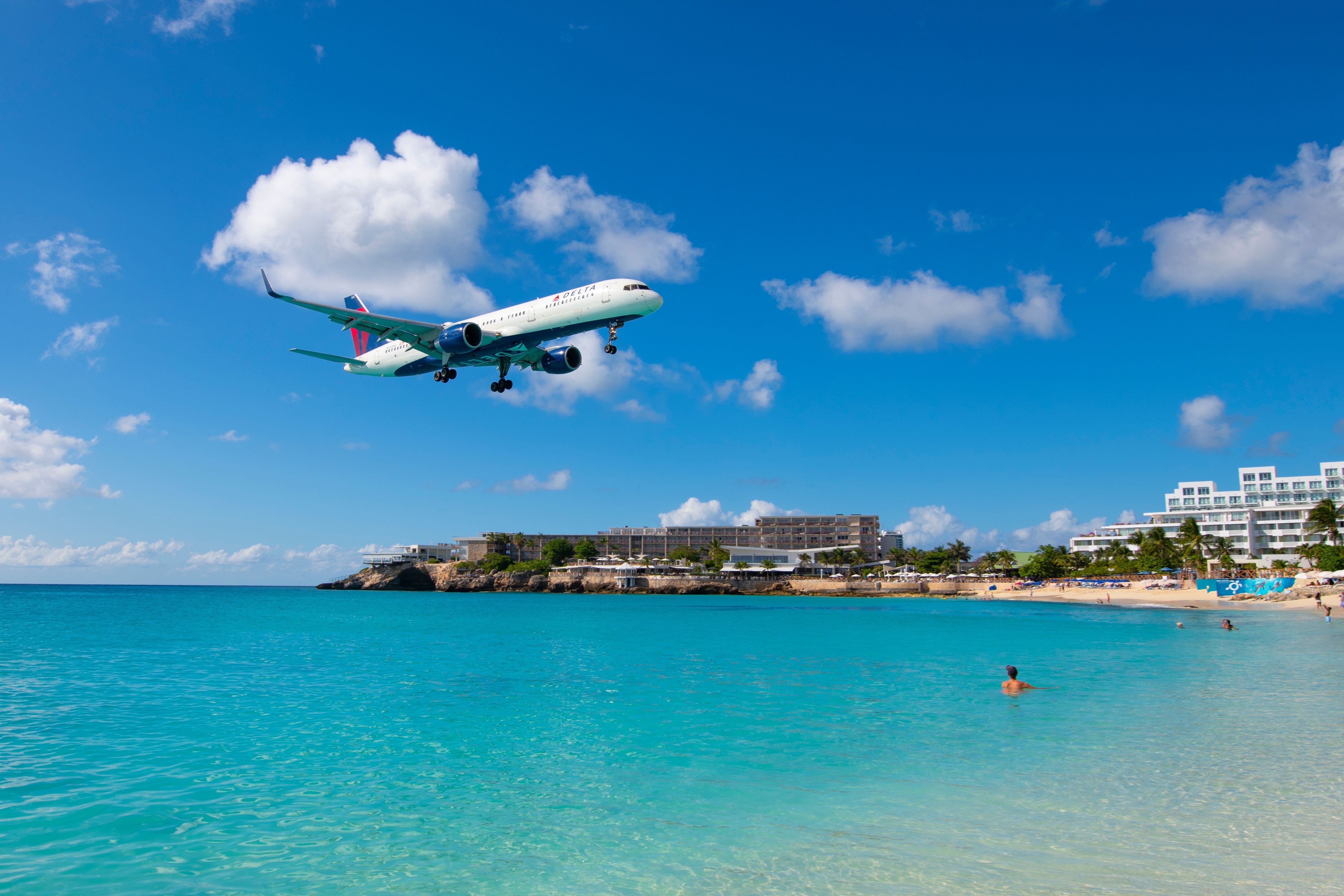 ST MAARTEN - NOV. 27, 2023: Delta Air Lines Boeing 757 flying over Maho Beach before landing on Princess Juliana International Airport SXM on Sint Maarten, Dutch Caribbean.