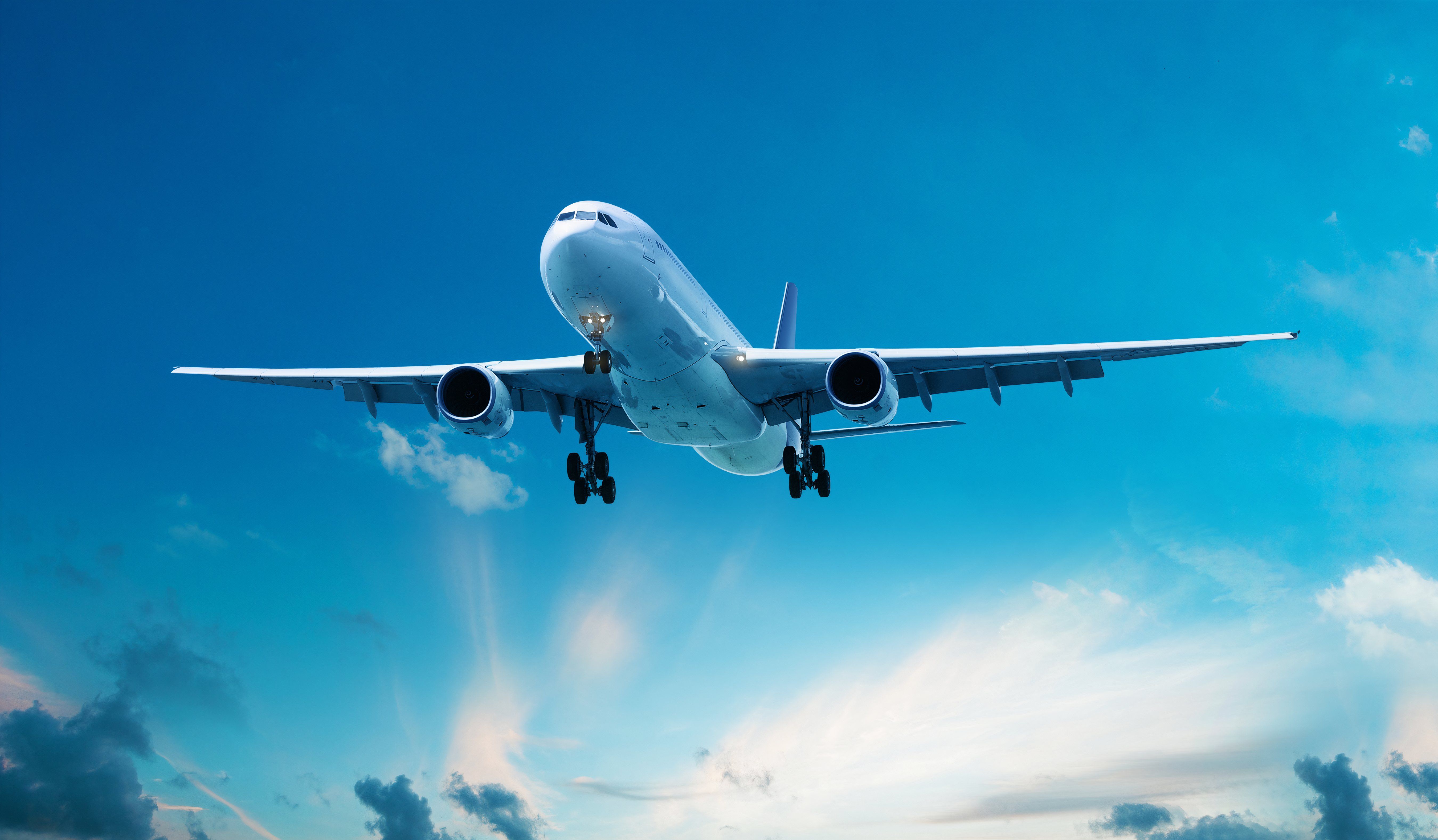 Clear air turbulence: Commercial passenger airplane flying in the amazing blue sky and dark clouds.