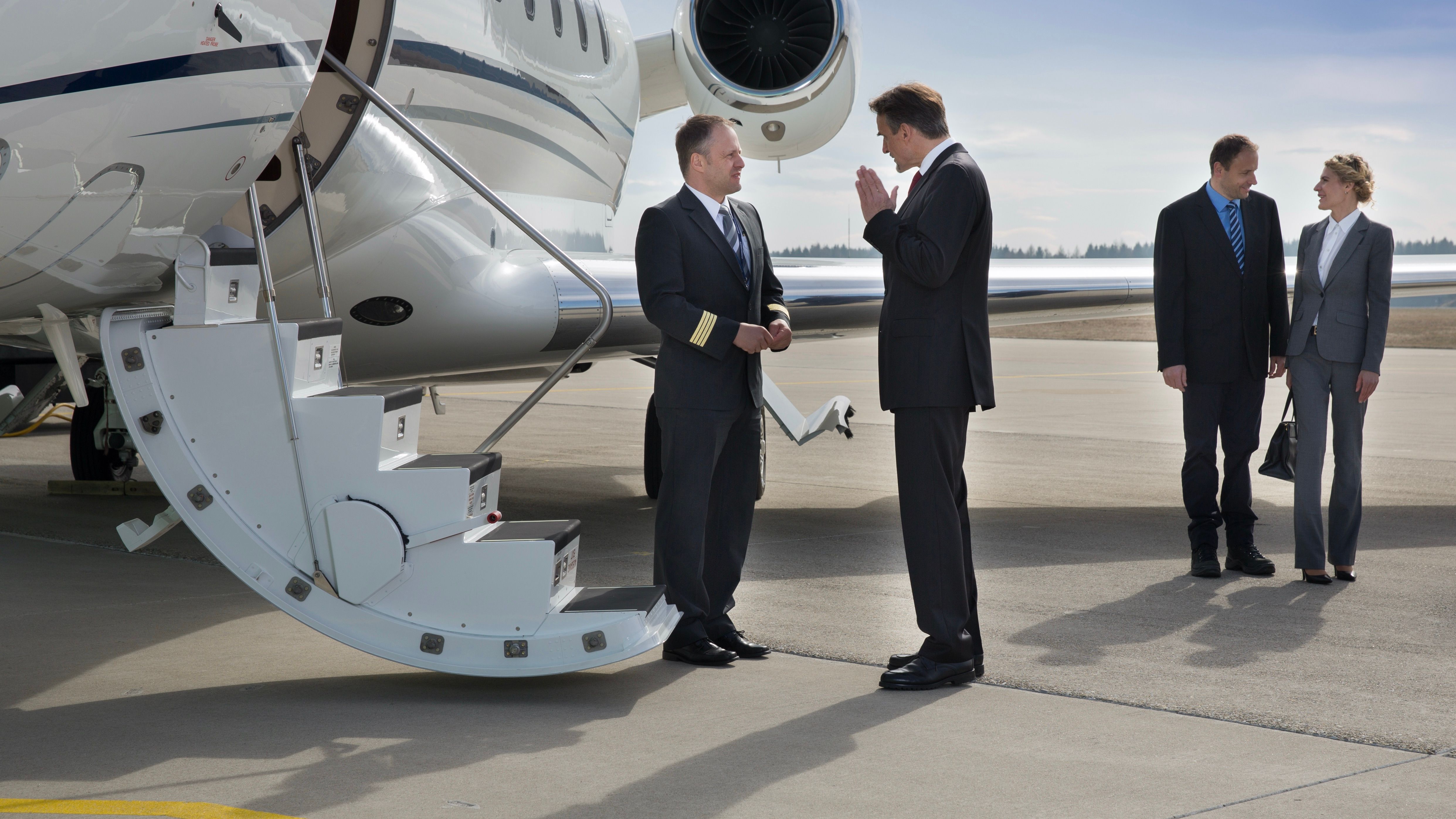 Private jet with pilot and executives boarding