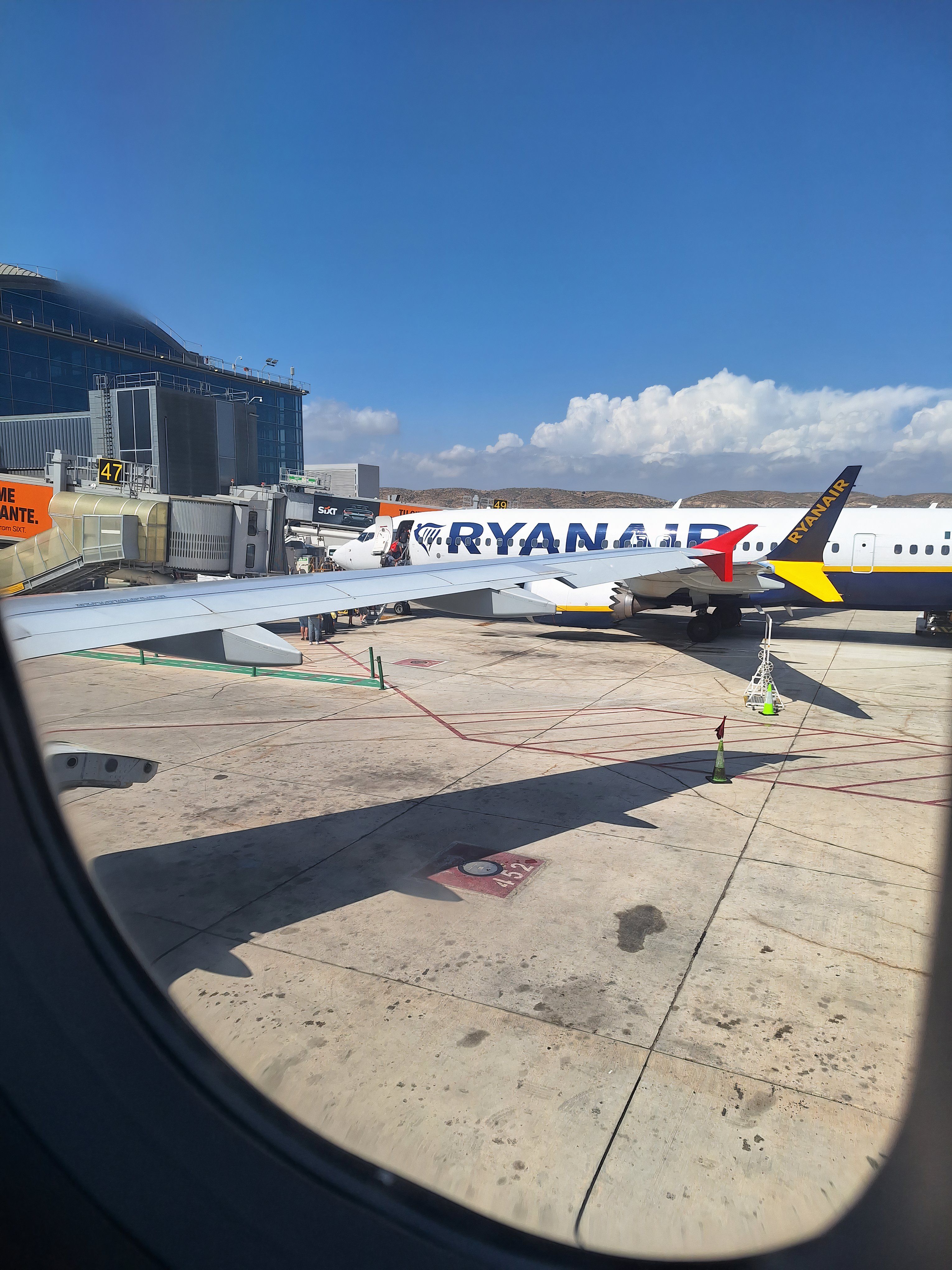 looking out of the window of a Lauda A320-200