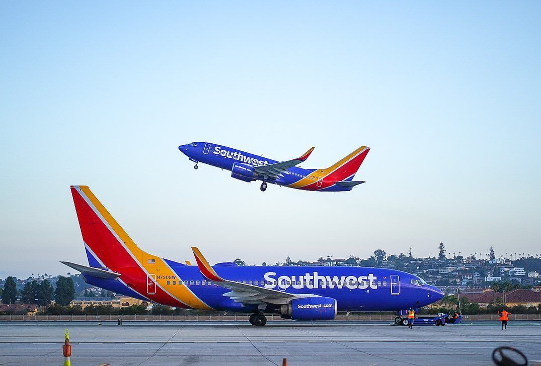 Southwest Airlines Boeing 737-700 taking off in the background.