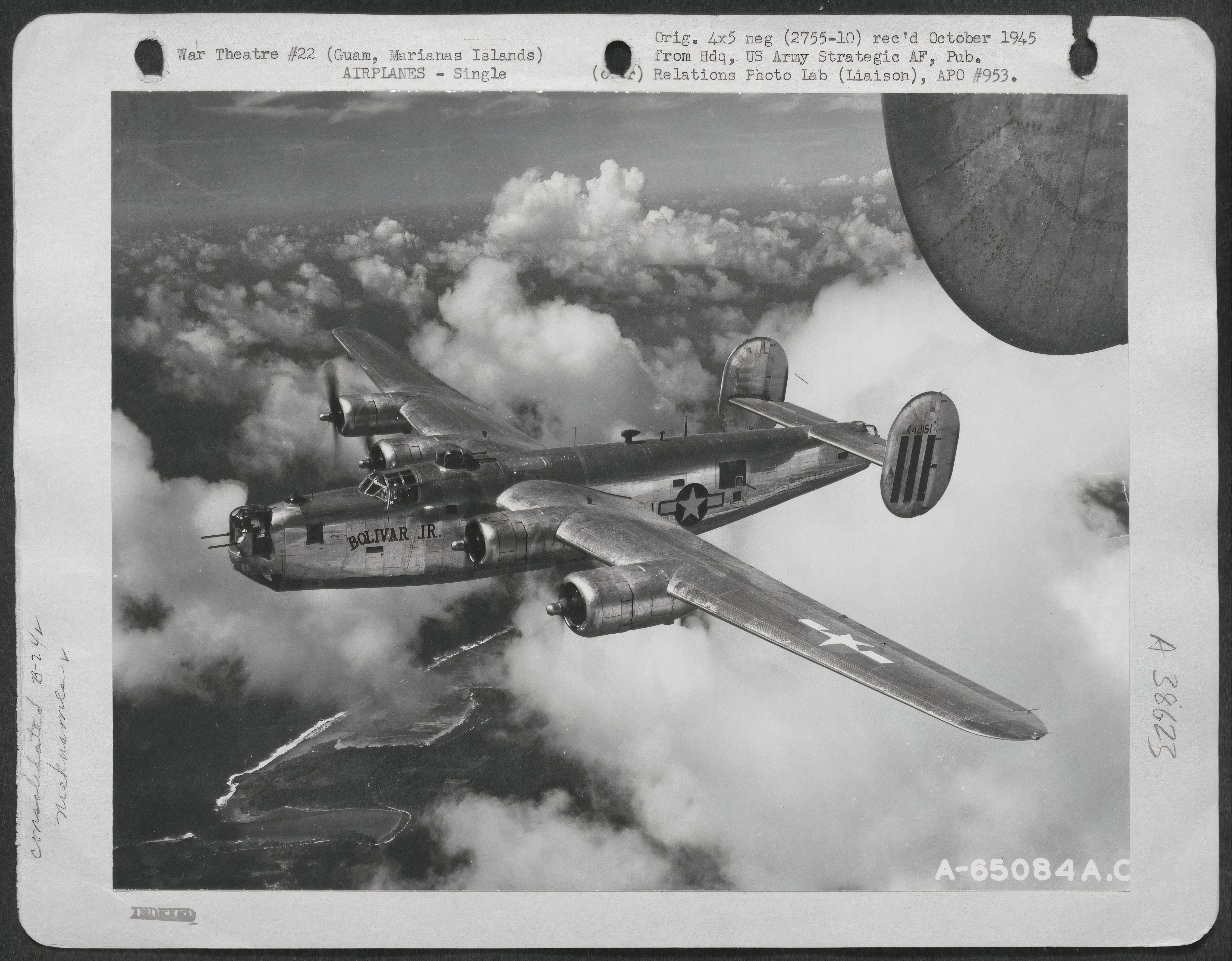 A B-24 Liberator flies towards Harmon Field , Guam, Marianas Islands, on June 6, 1945.