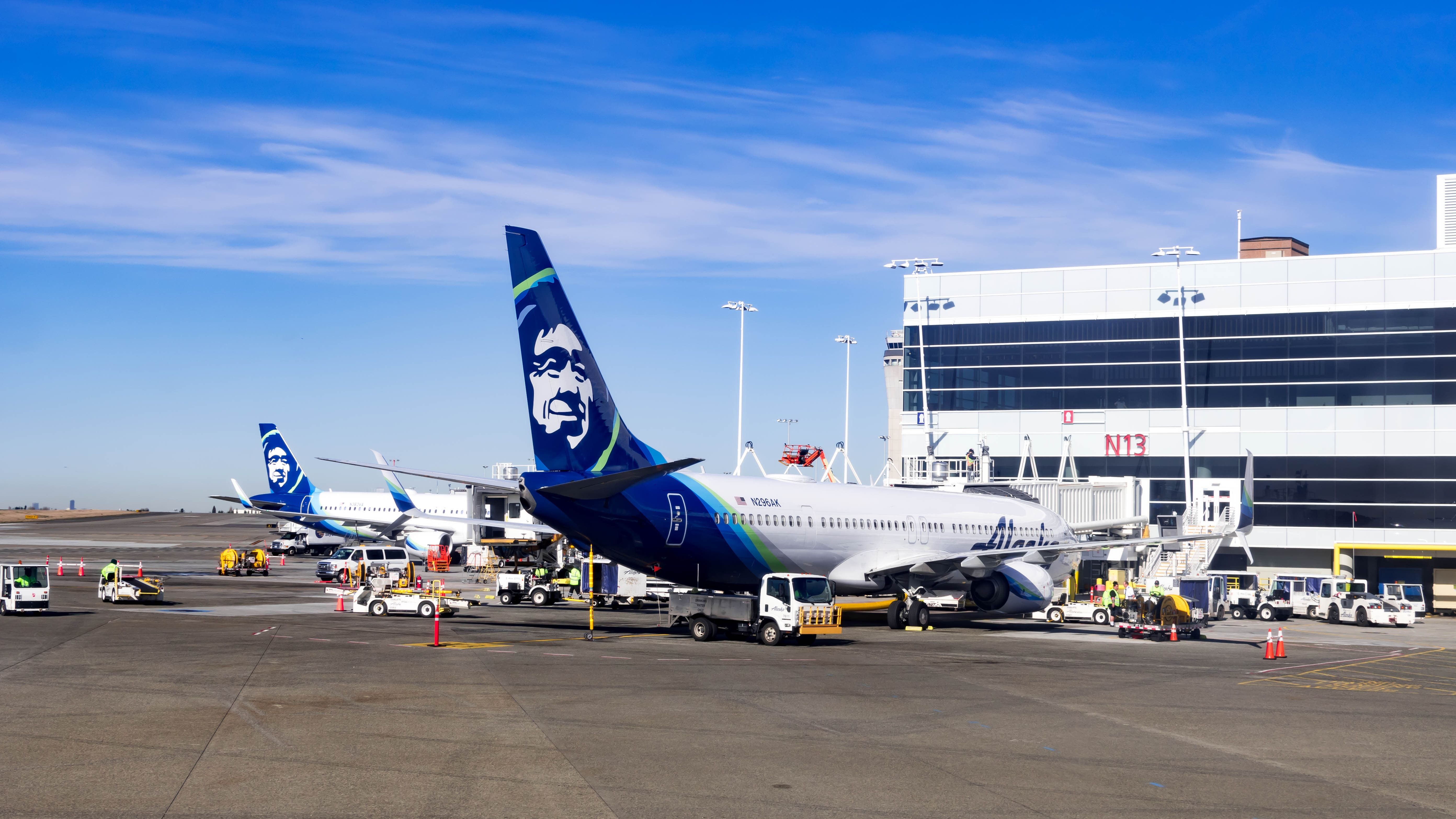 Alaska Airlines aircraft parked at the gates at Seattle-Tacoma International Airport SEA shutterstock_1766083010