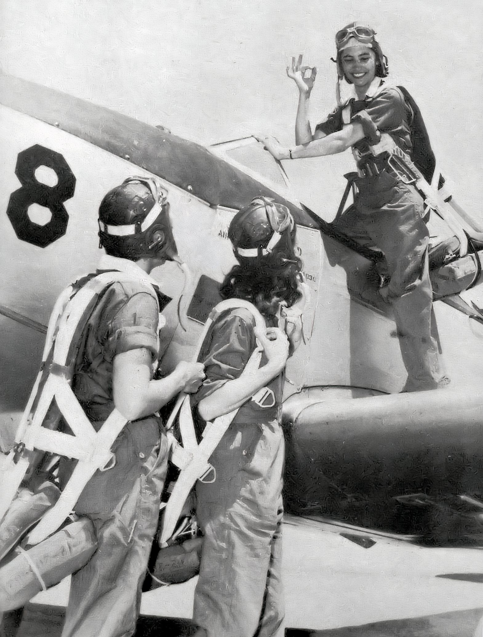 WASP trainee pilot climbs into the cockpit of her aircraft.