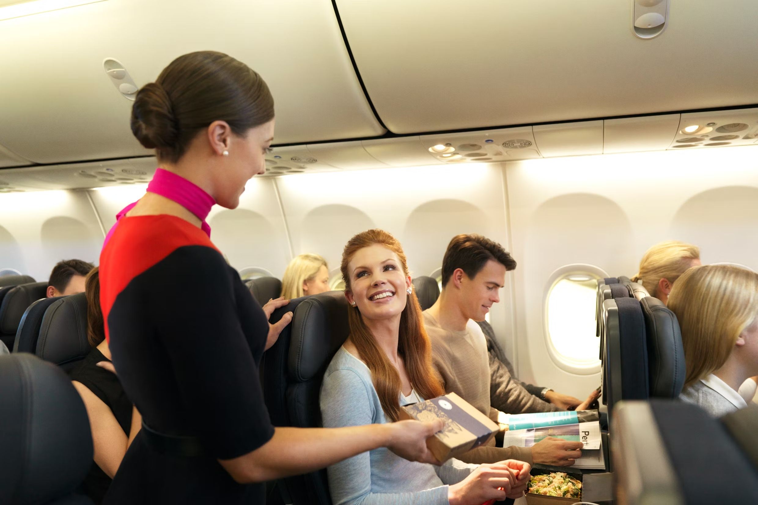 Qantas Flight Attendant Serving Meal Onboard