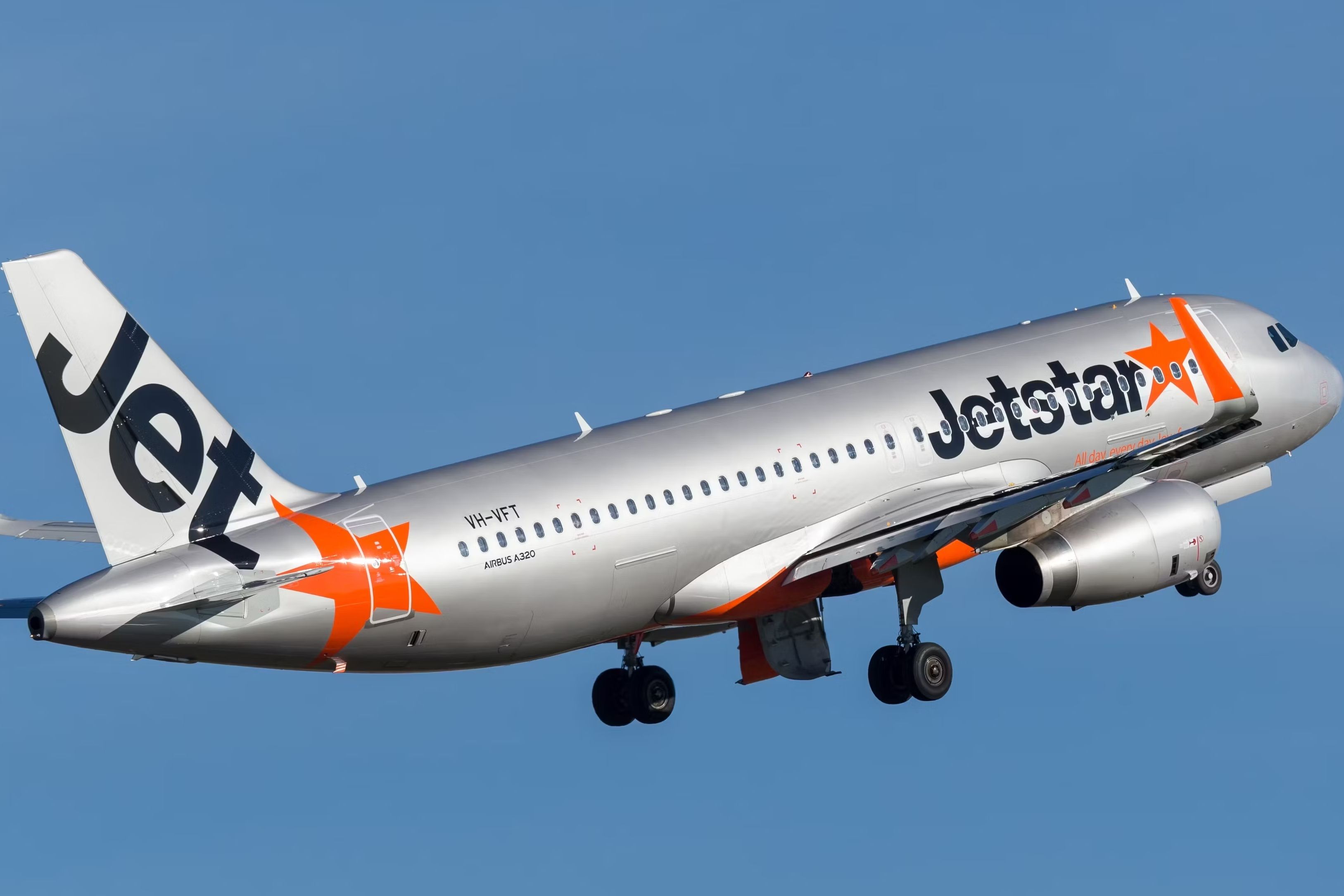 A Jetstar Airbus A321 flying in the sky.