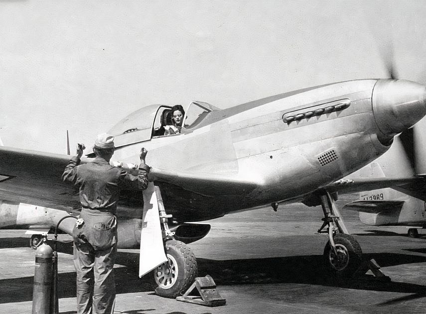 Black and white image of a WASP pilot in the cockpit of a P-51.