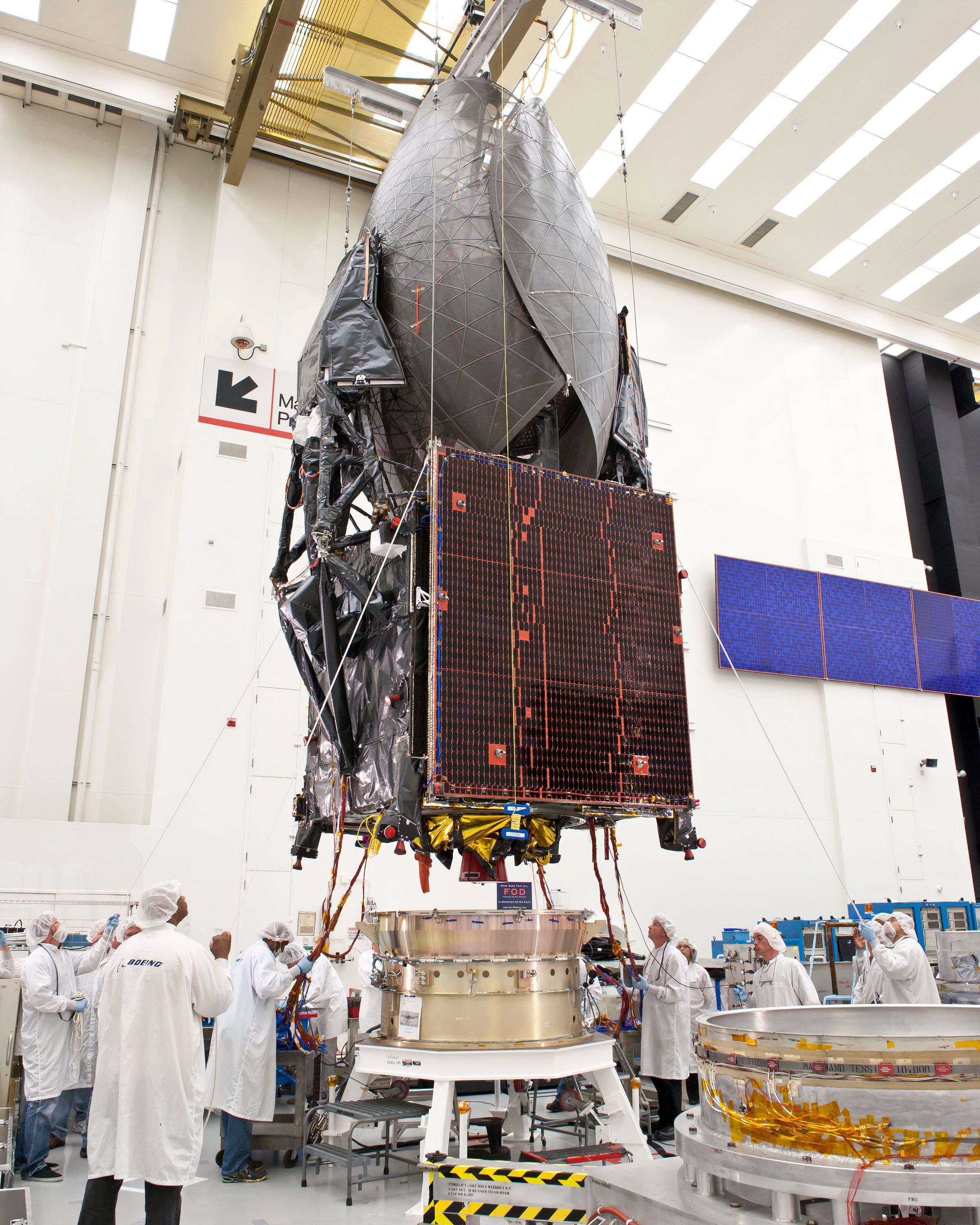 A satellite being readied for launch by NASA engineers.