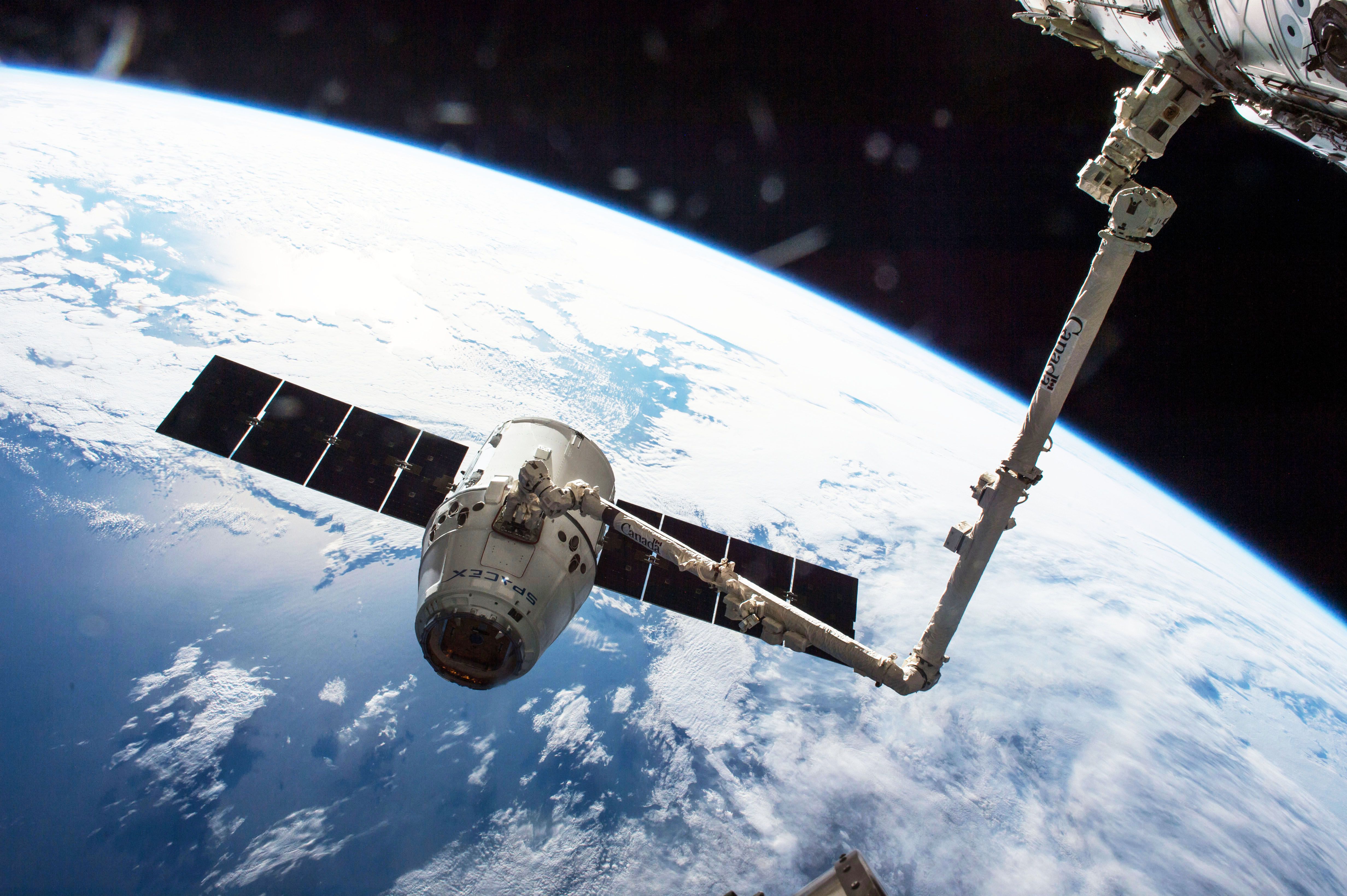 Photo of SpaceX's Dragon supply ship being recieved by Canadarm2