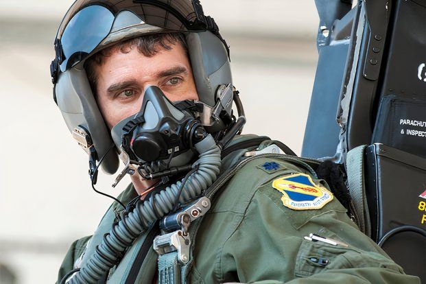 USAF pilot sitting in the cockpit looking off to the distance