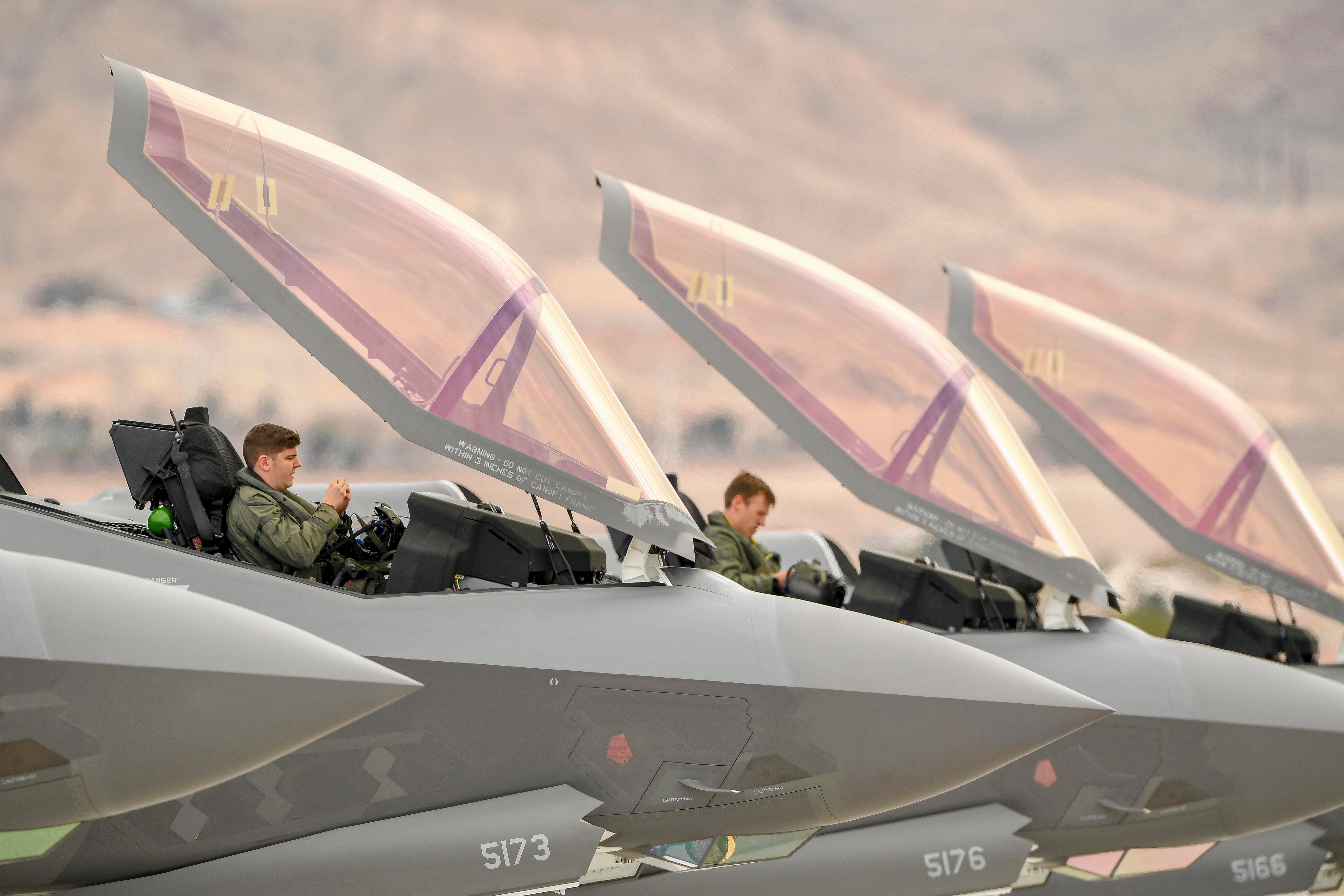 F-35 pilots sitting in their cockpits prior to flight. 