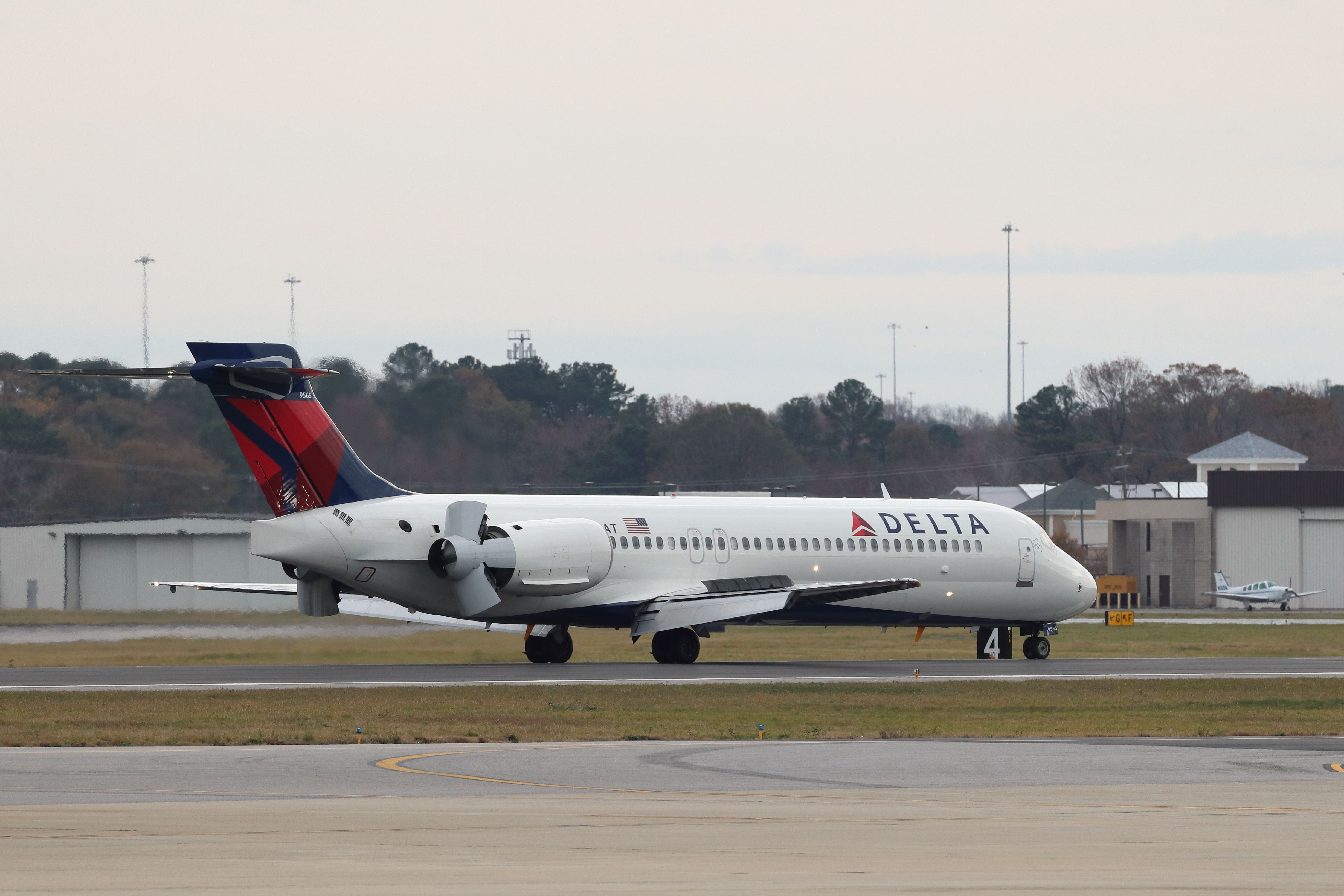 Delta Air Lines Boeing 717-200 slowing down on the runway.