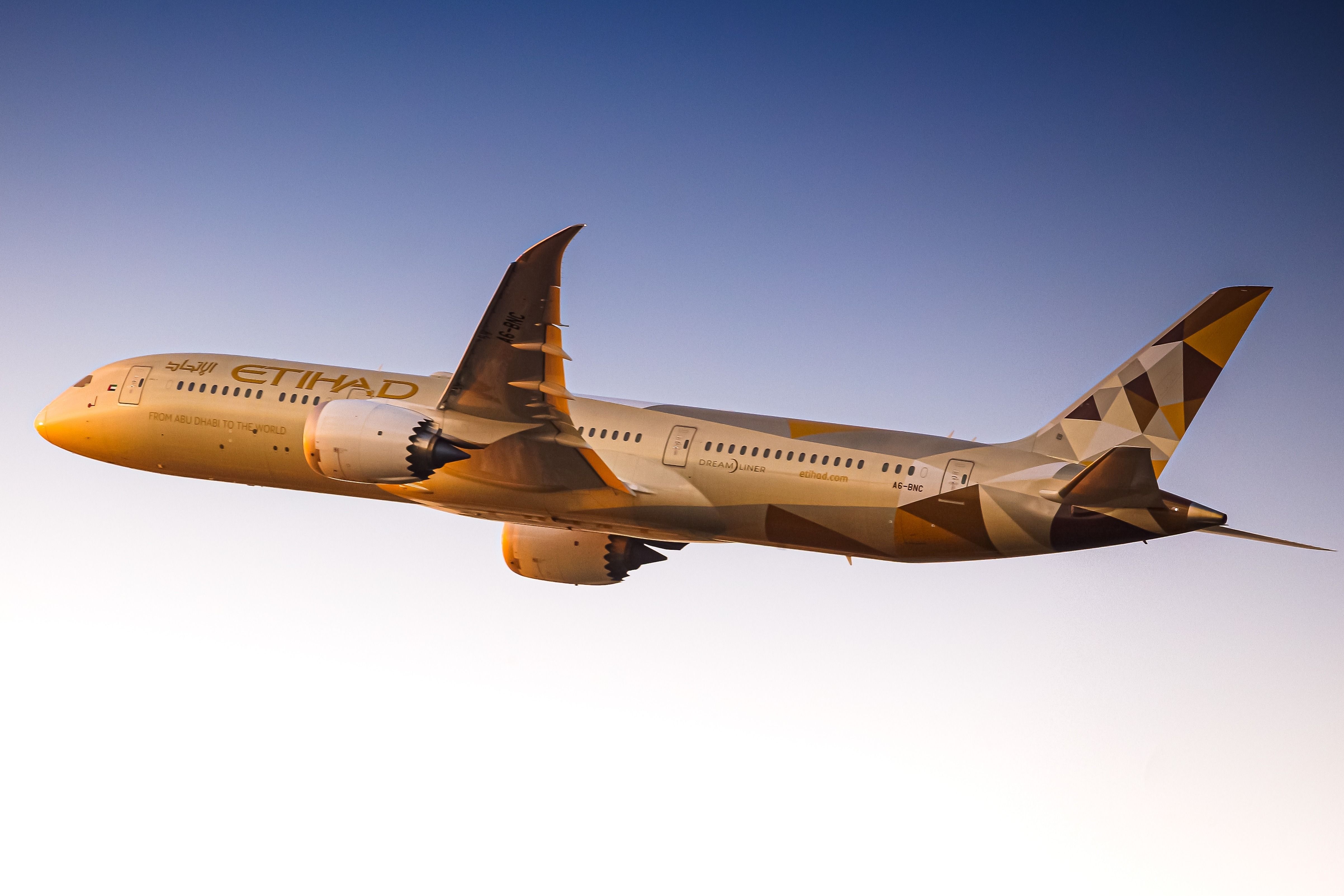 A Boeing B787-9 owned by Etihad Airways departing at sunset