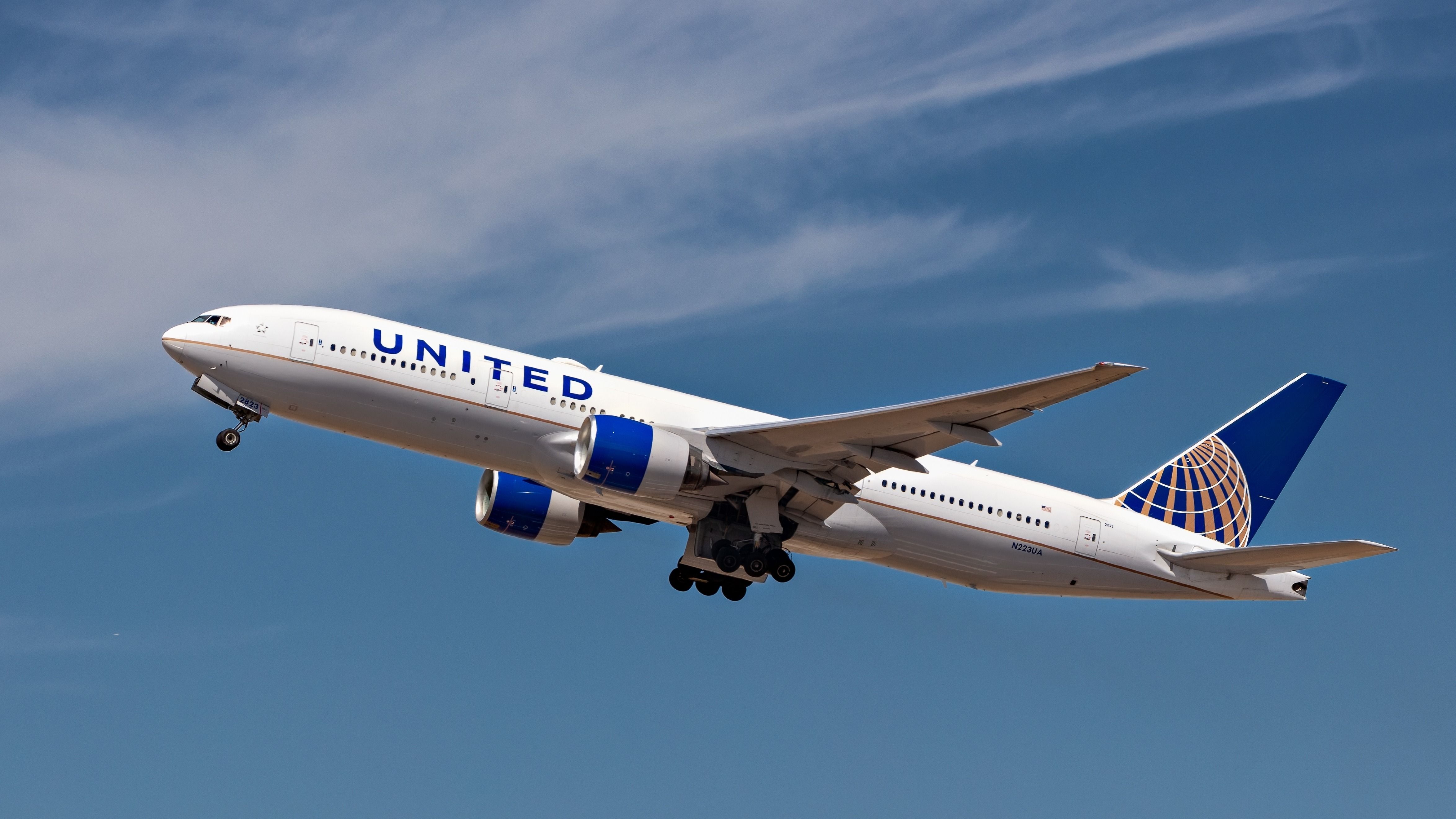 United Airlines, Boeing 767 Aircraft taking off into a steep climb against a dramatic blue sky