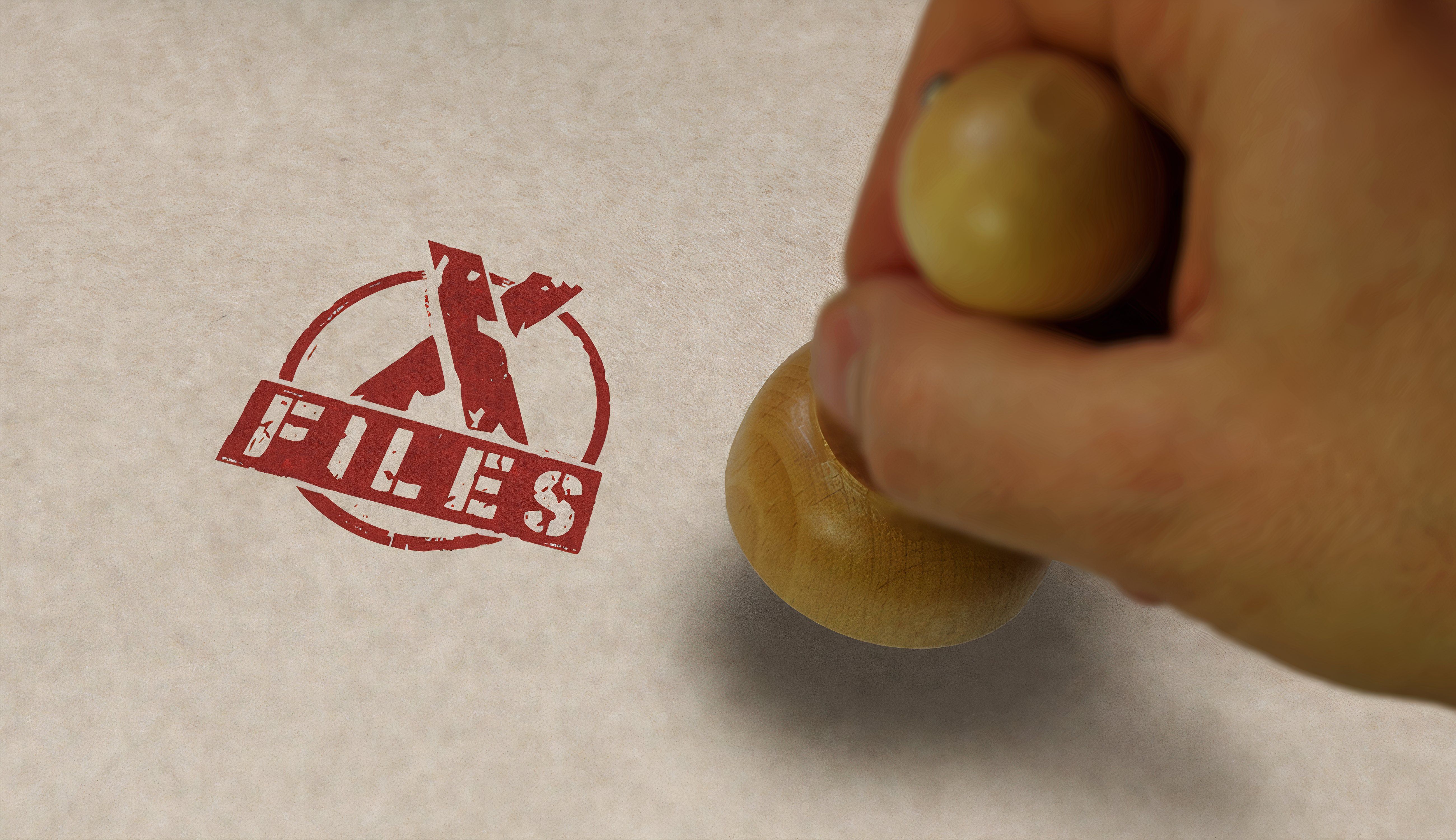 X-Files symbol stamped on paper.