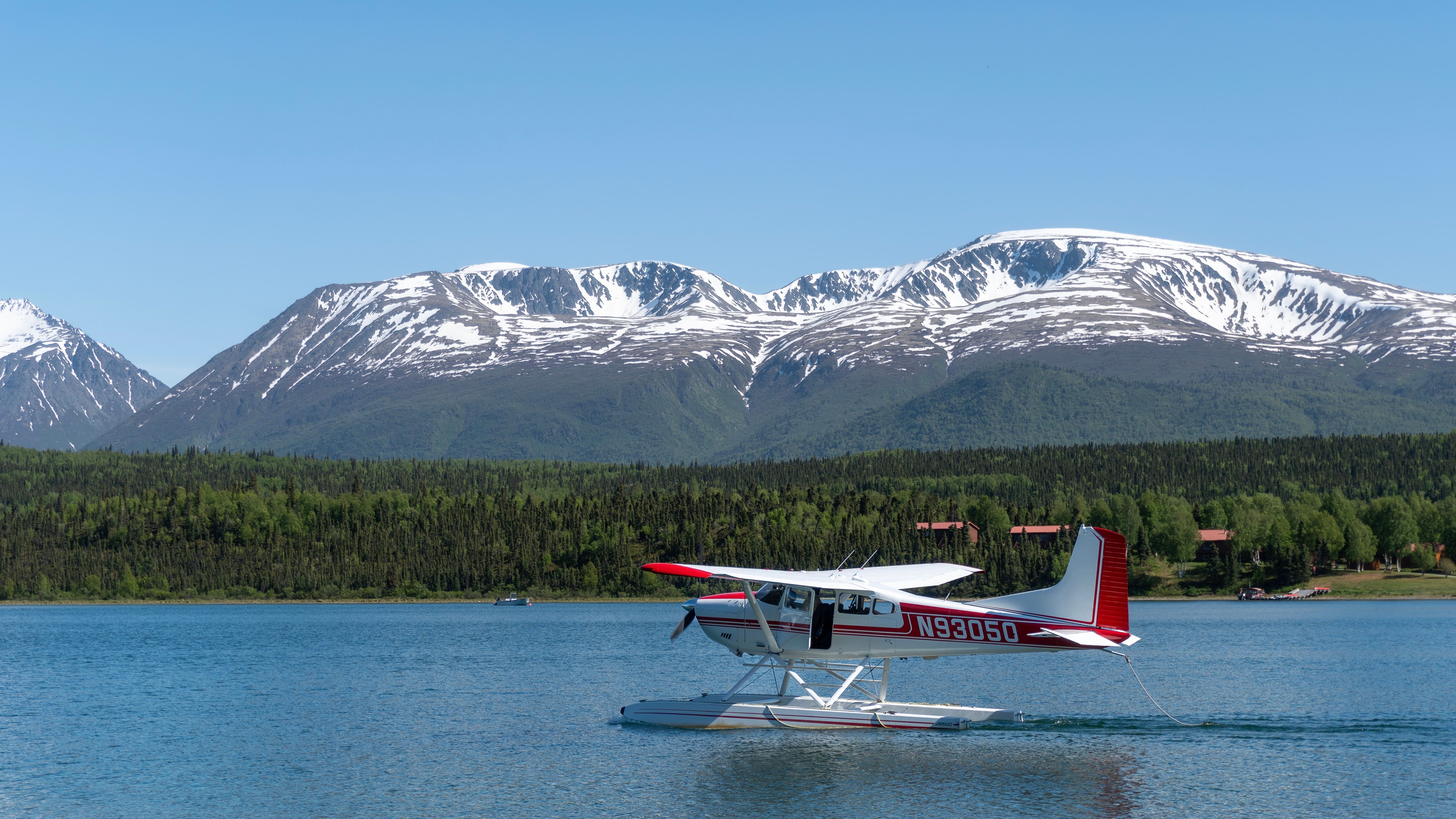 Cessna Skywagon  185 on lake by mountain