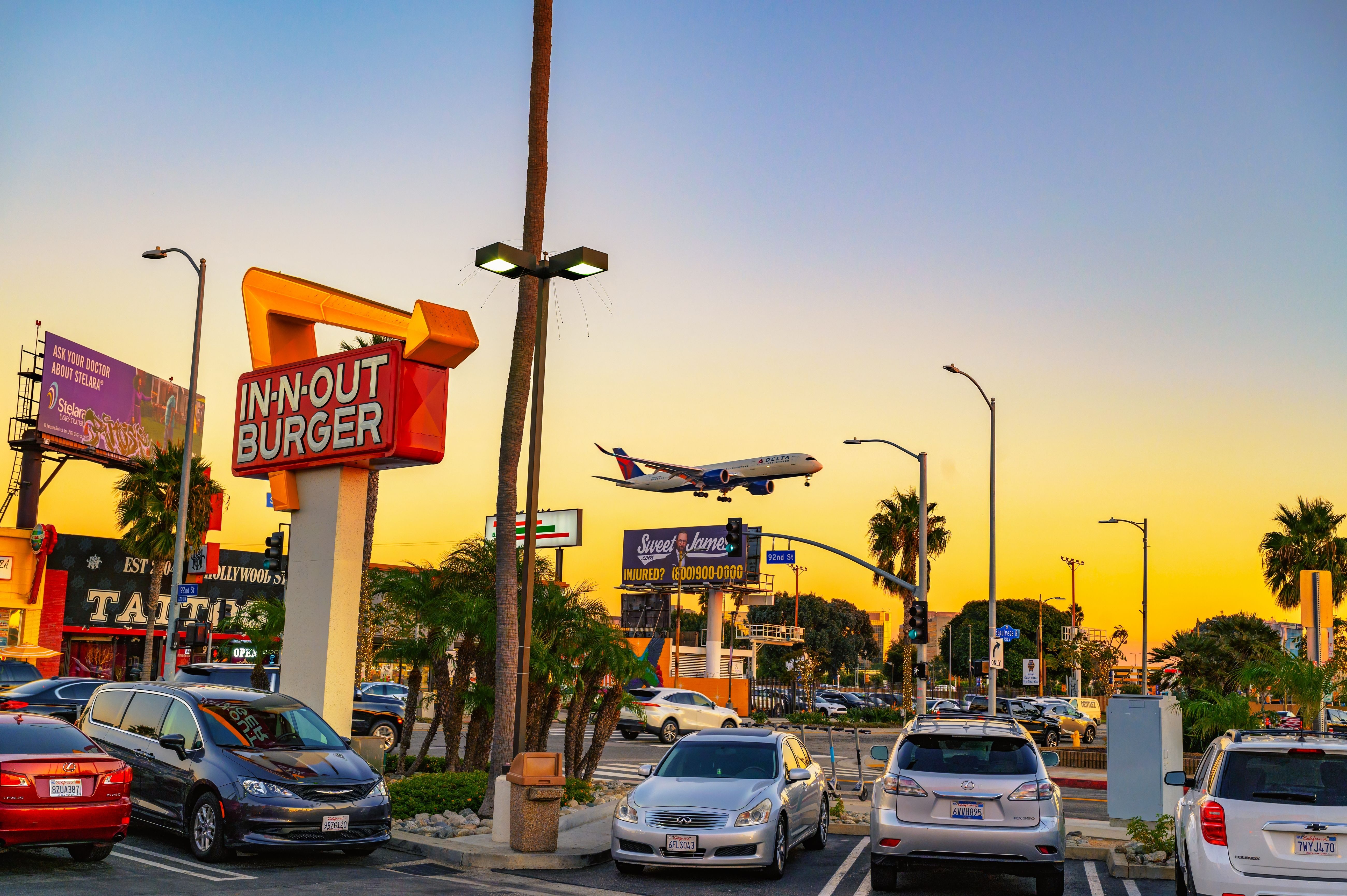 A Delta Air Lines Airbus A350 landing over the iconic In-N-Out on Sepulveda Blvd.