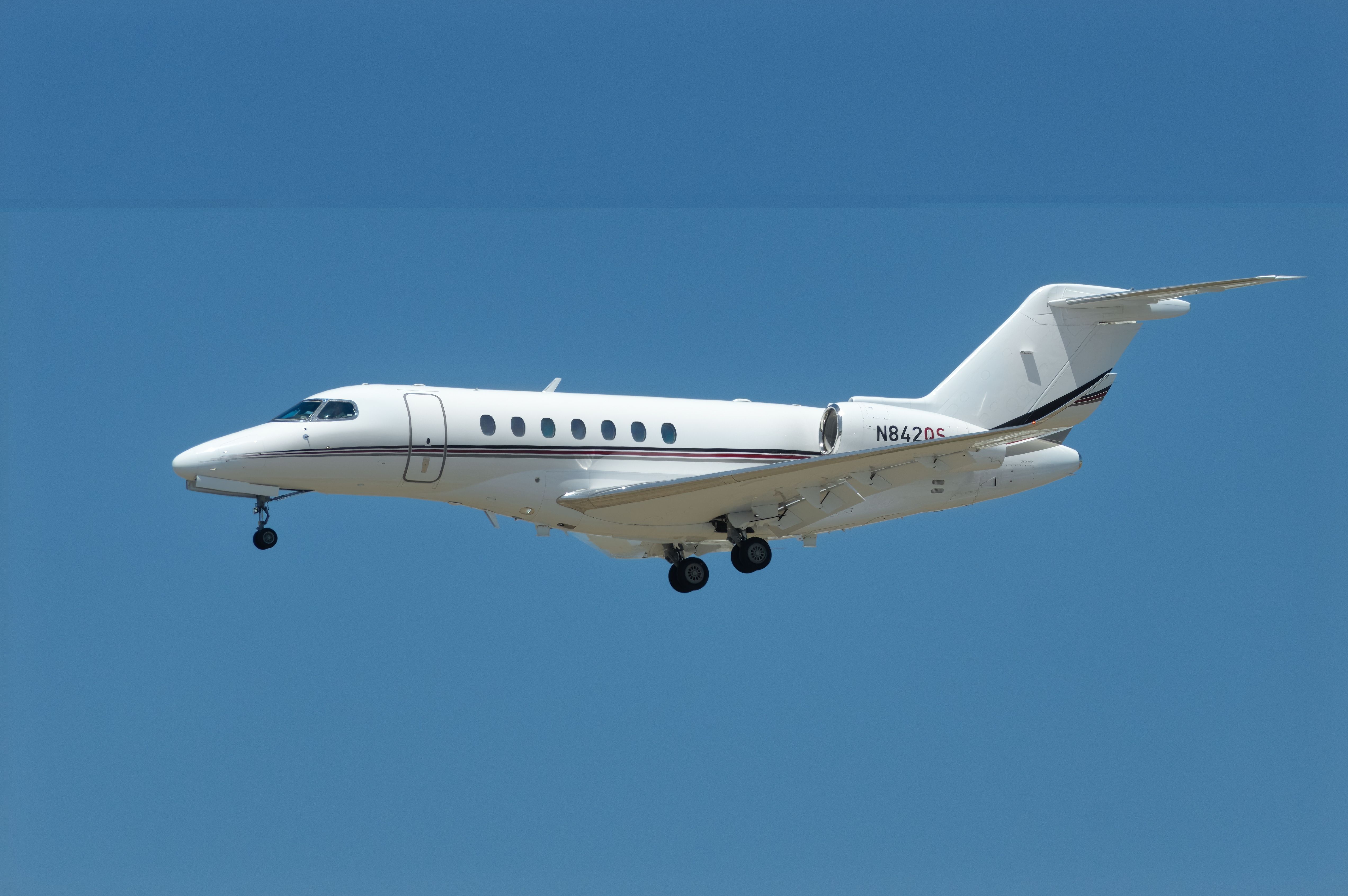 Cessna 700 Citation Longitude with registration N842QS shown on final approach to LAX