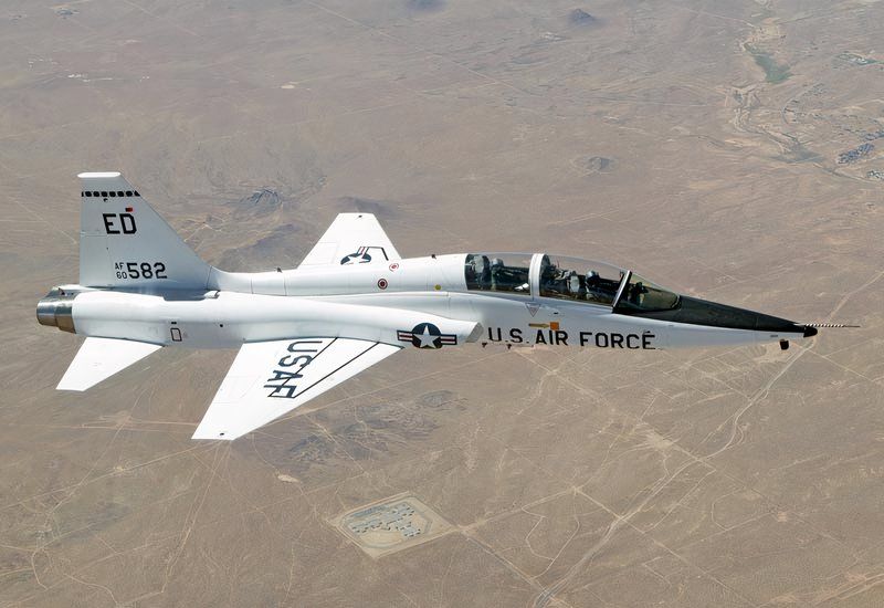 T-38 Talon flying over what looks like a desert.