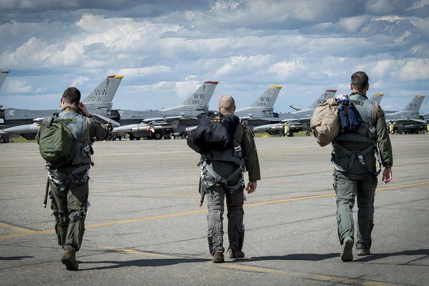 USAF pilots walking towards their aircraft.