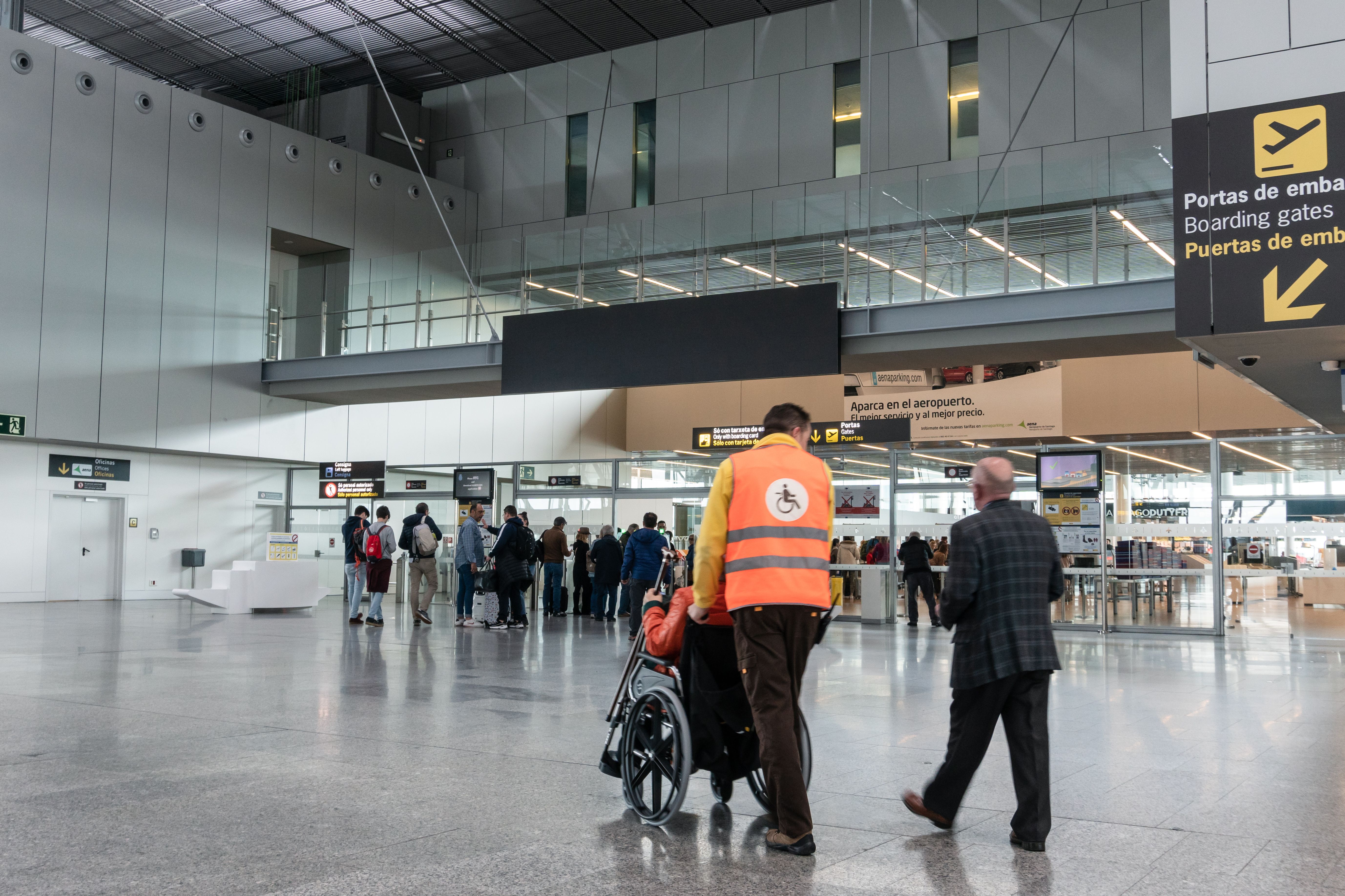 Passenger with reduced mobility being escored through the airport shutterstock_1377016847