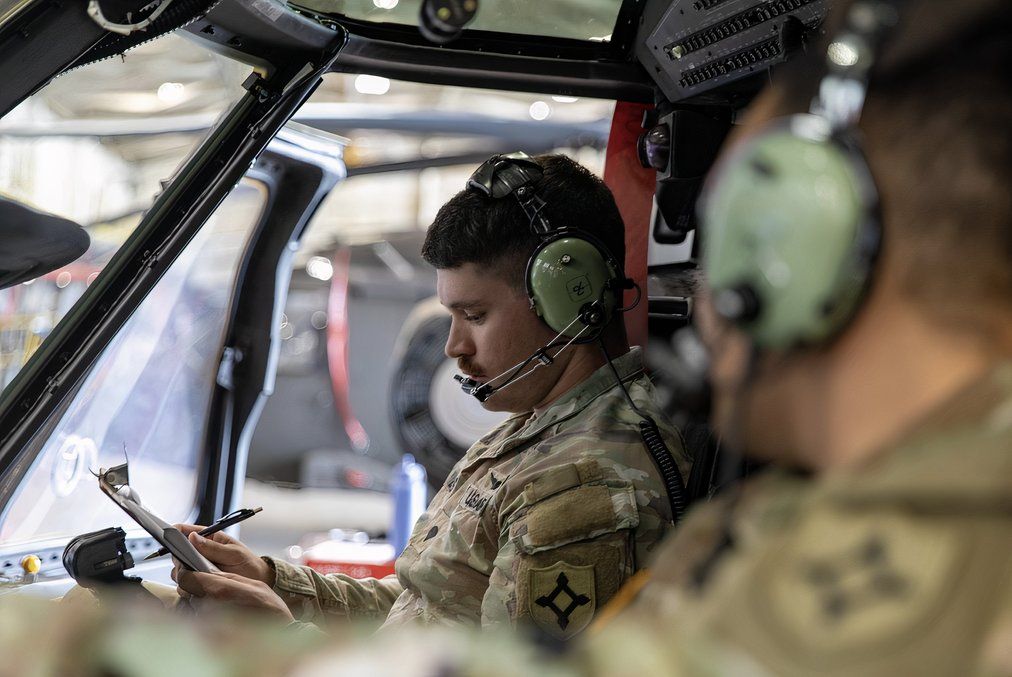 Helicopter pilots sitting in the cockpit.