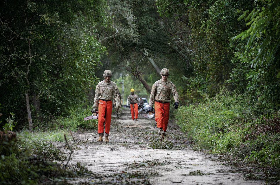 Soldiers walk through a devastated street.