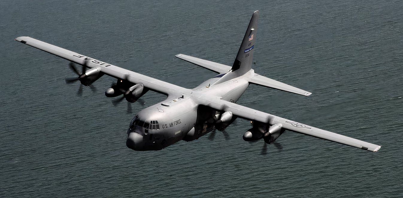 WC-130J flying over a body of water