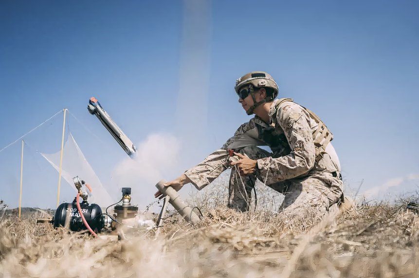 Marine launching a switchblade drone