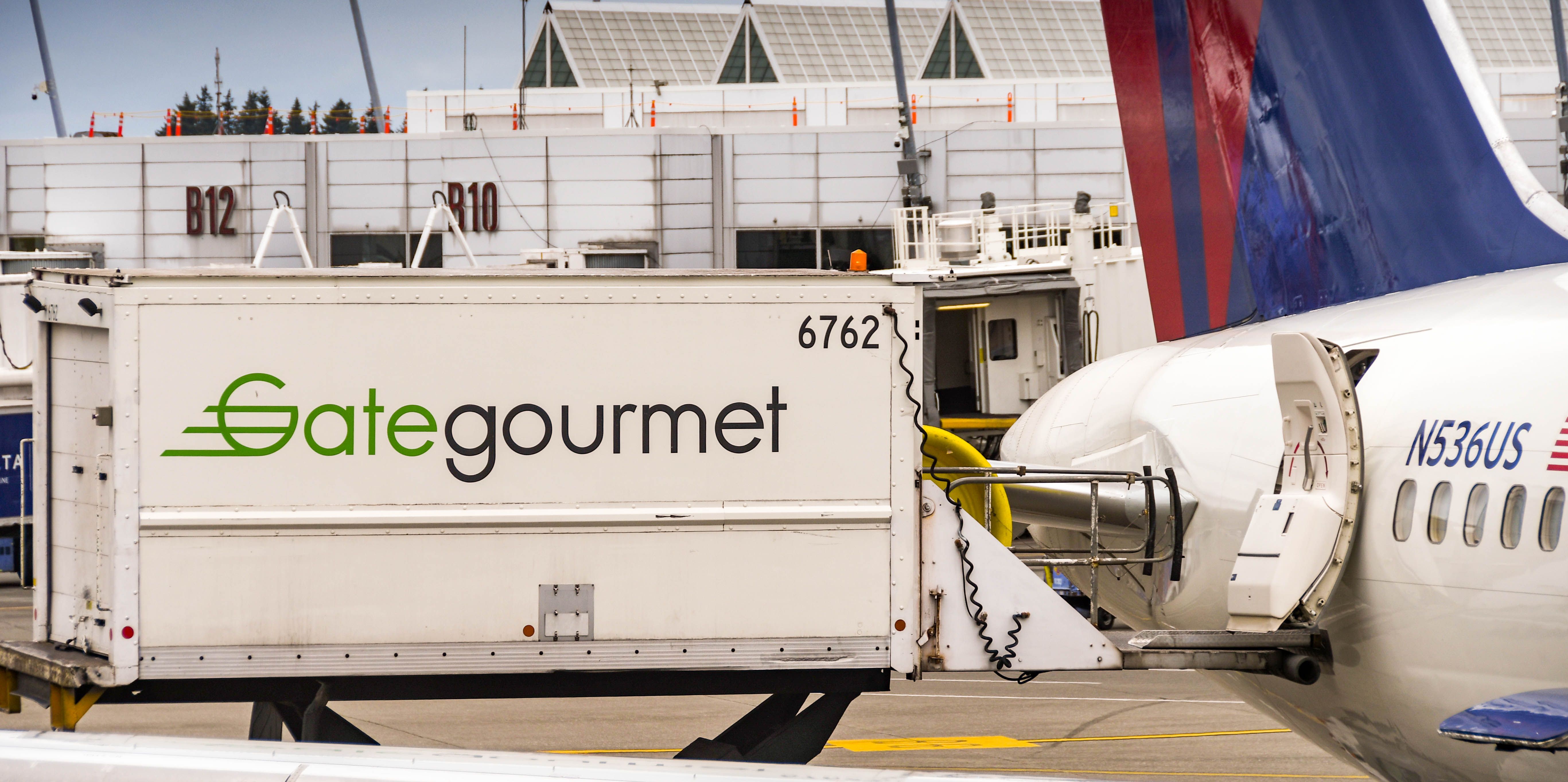 Delta Air Lines Boeing 757-200 being catered by a gategourmet truck at Seattle-Tacoma International Aiport.