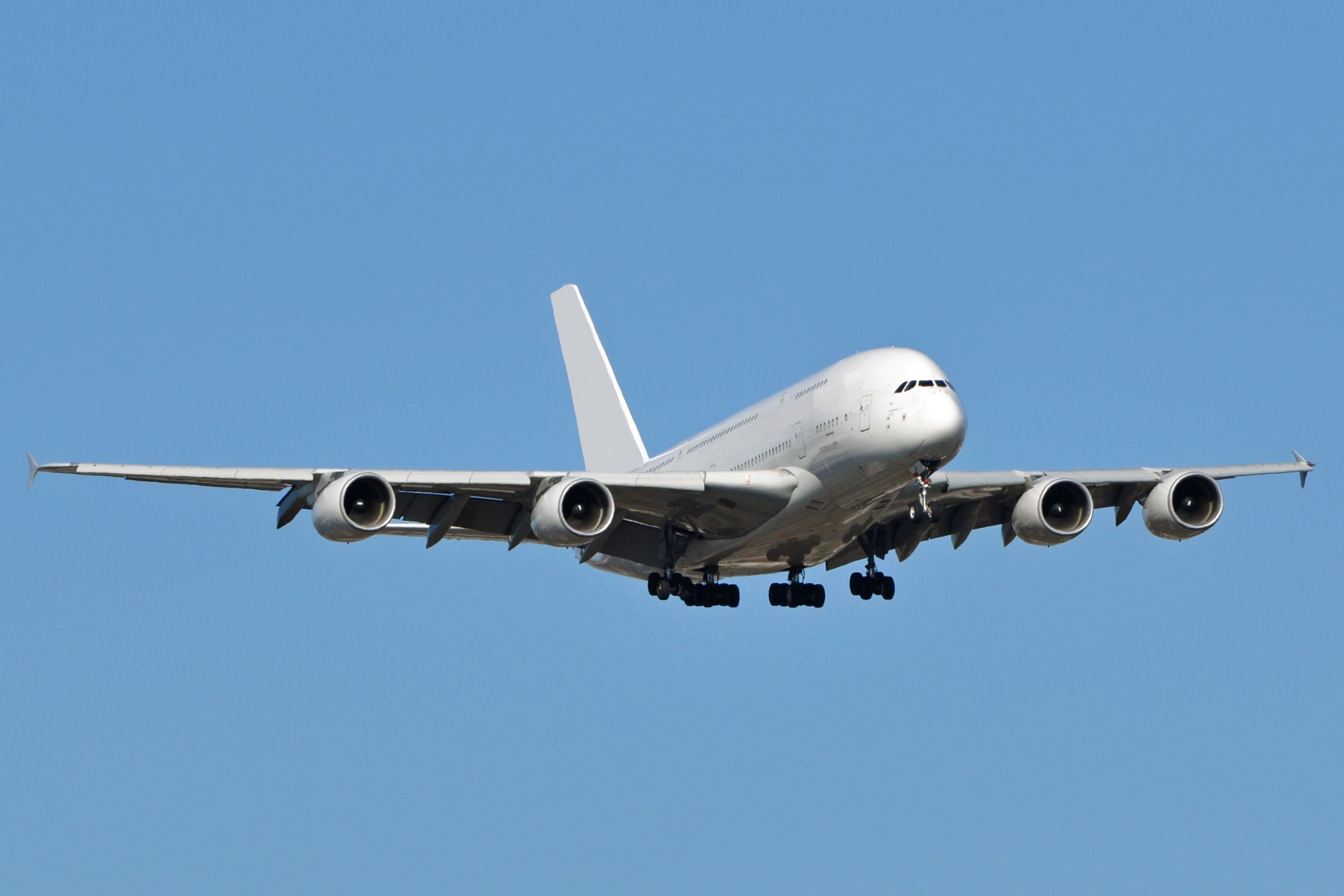 White Airbus A380 landing shutterstock_137142539