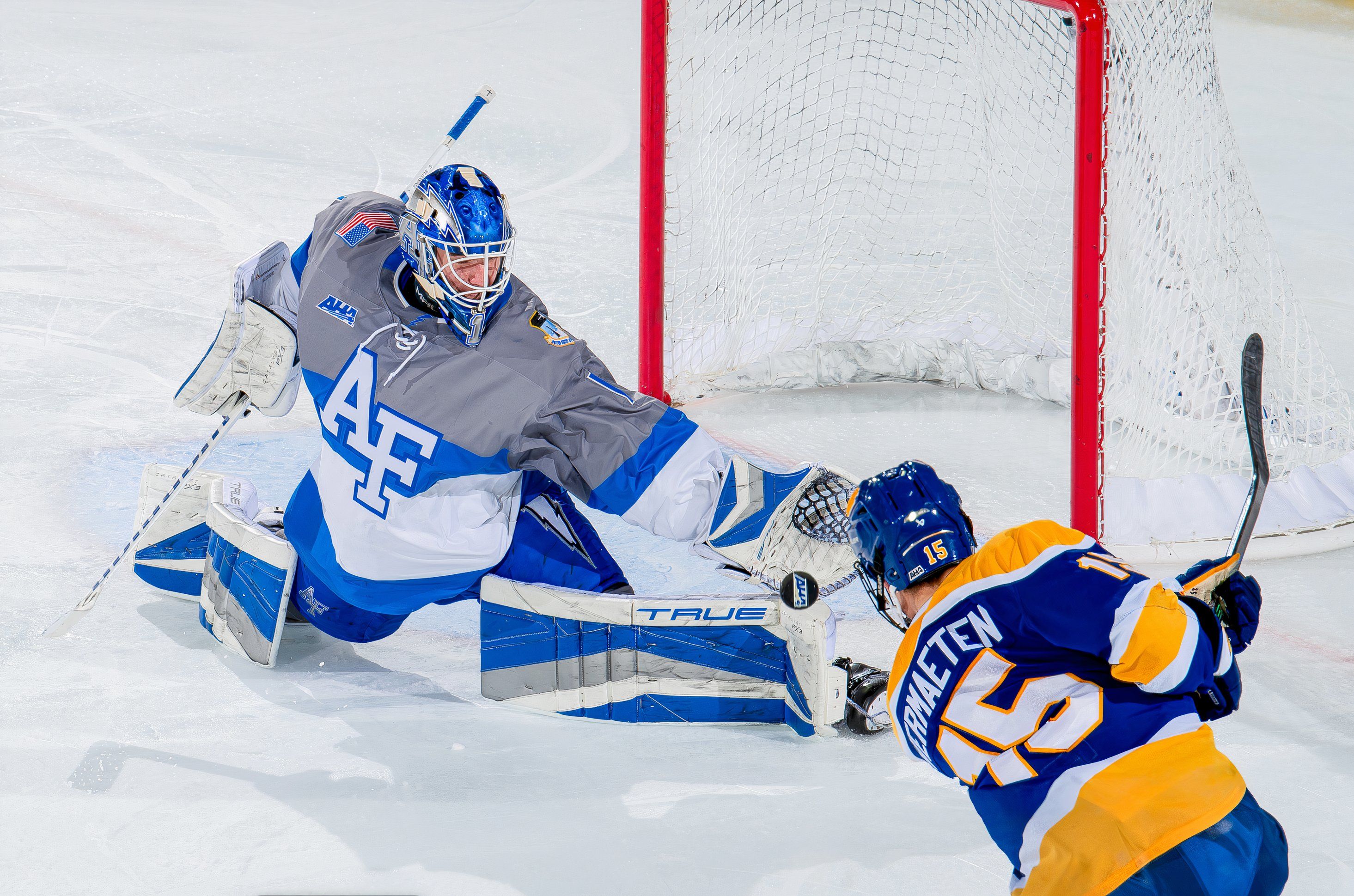 U.S. Air Force Academy -- Air Force's Guy Blessing makes a sliding save during a hockey game against Canisius University 