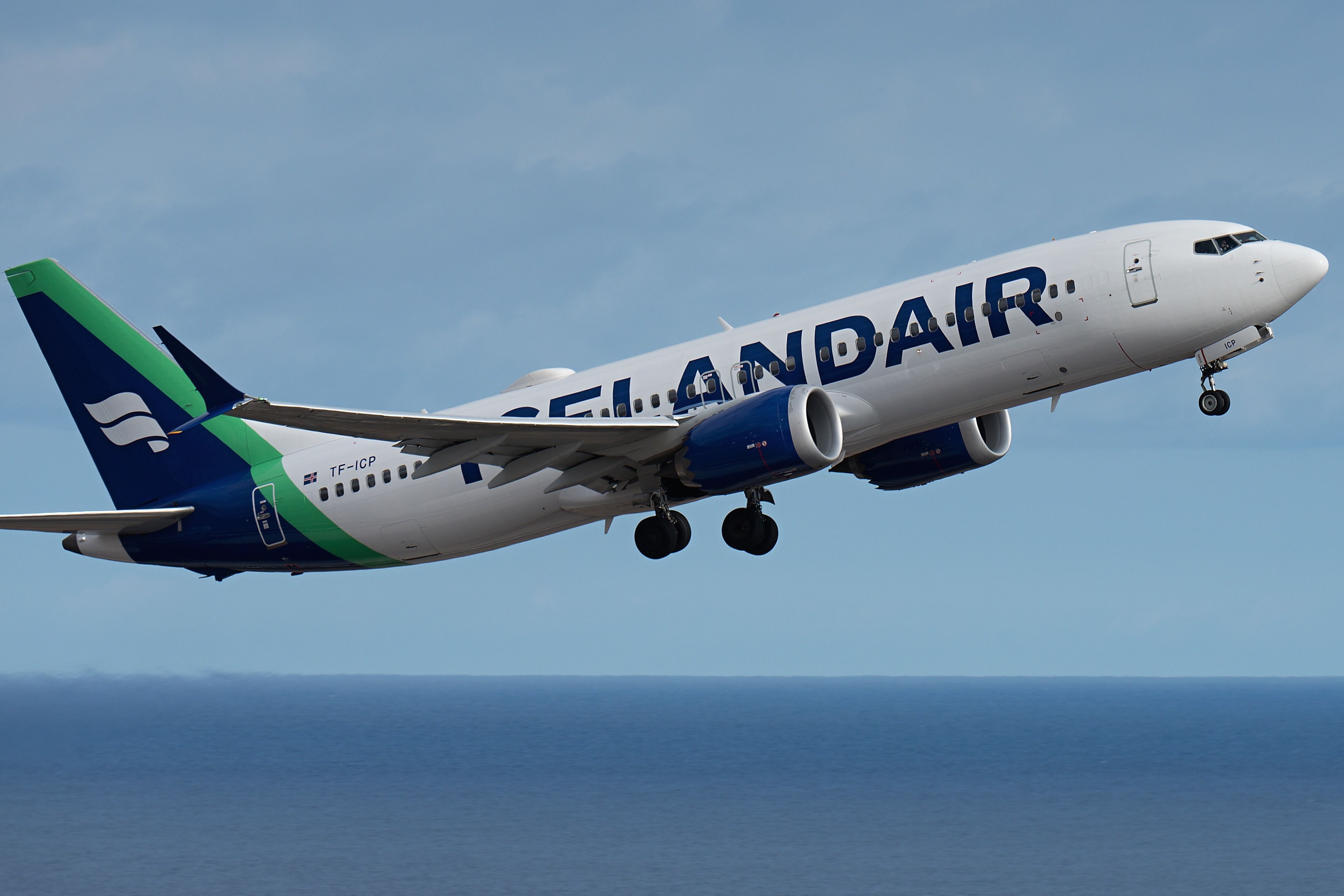 Icelandair Airlines Boeing 737 MAX 8 in the blue sky over the ocean