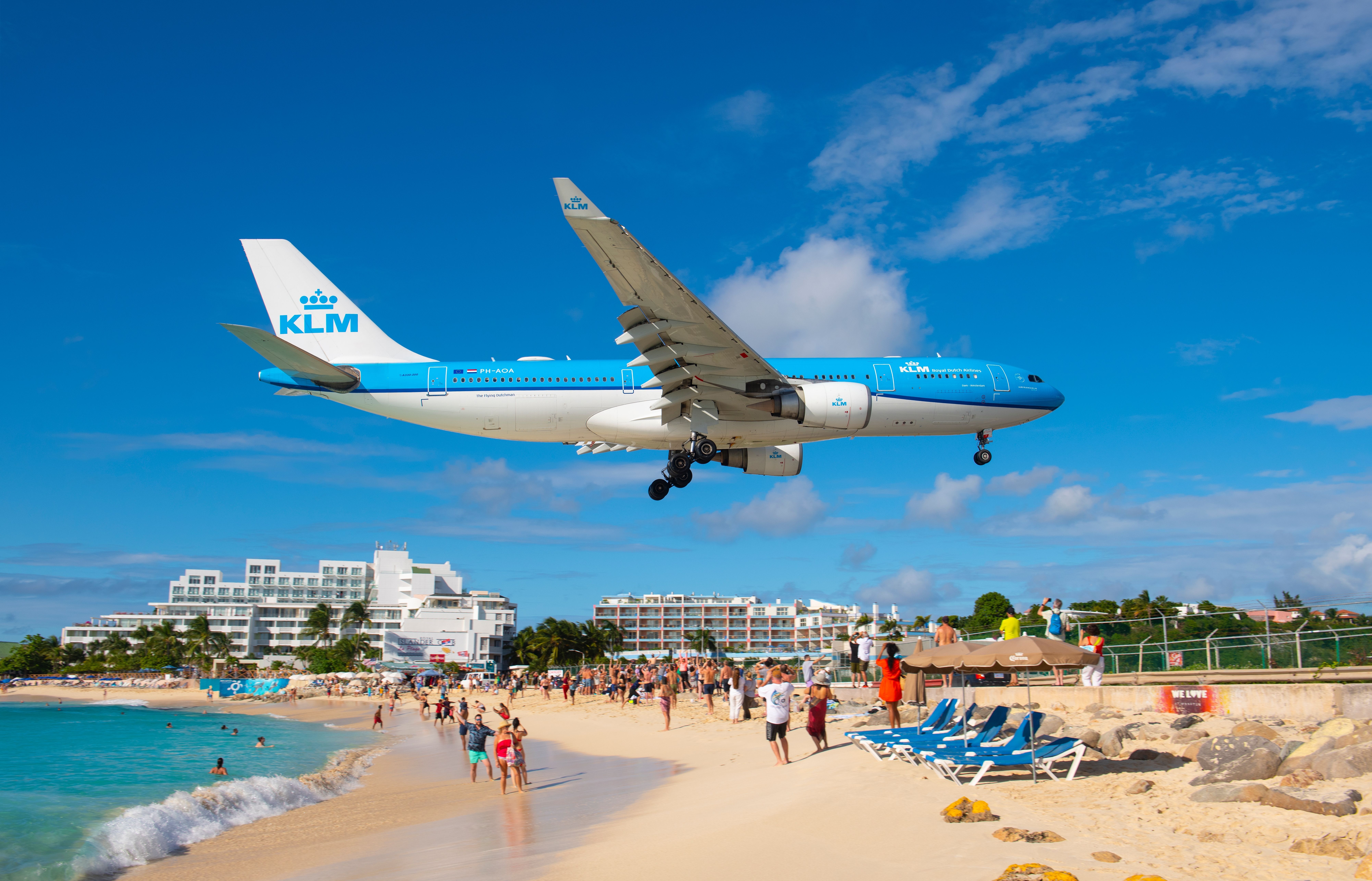  KLM Airbus 330 flying over Maho Beach before landing on Princess Juliana International Airport SXM on Sint Maarten, Dutch