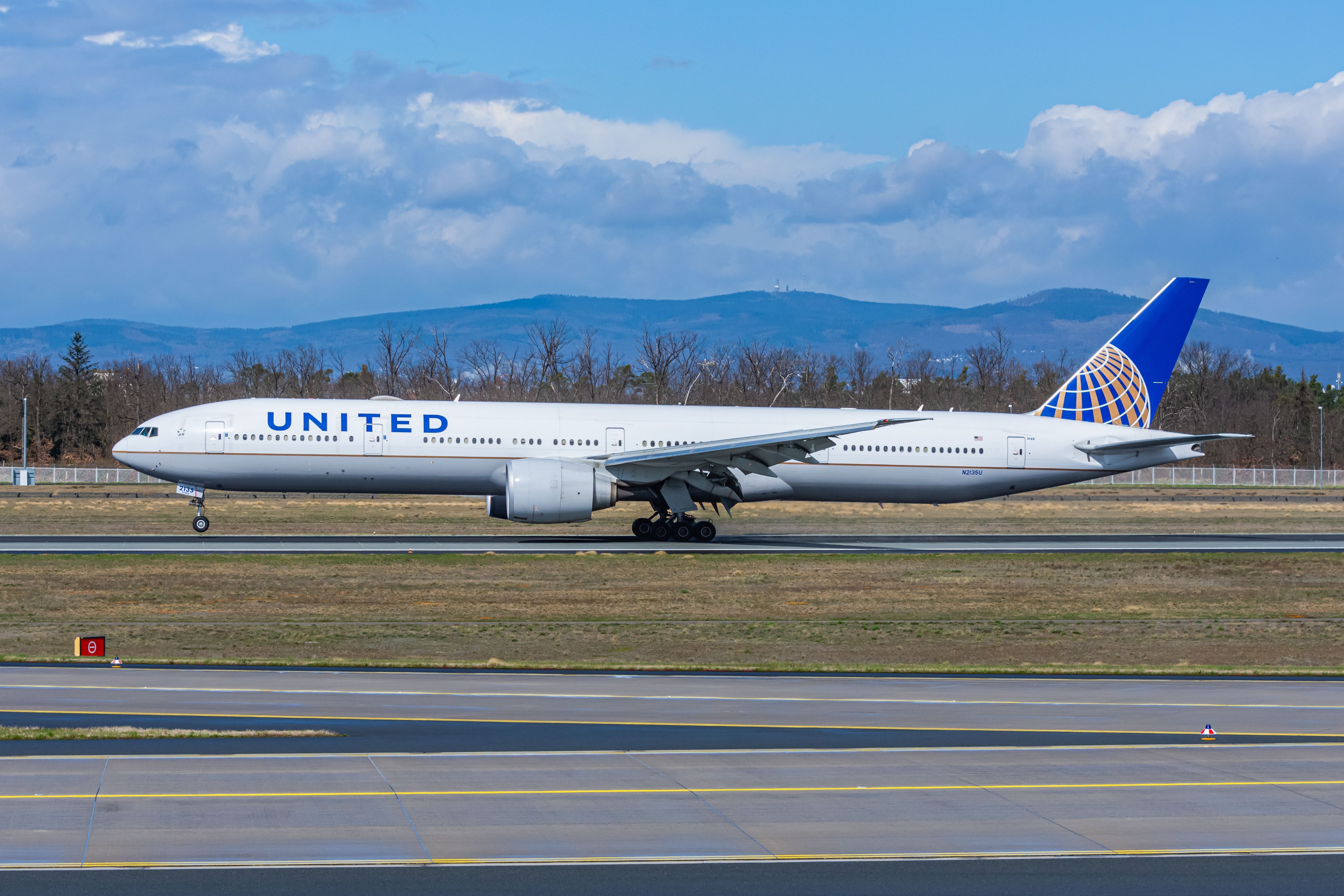 United Airlines Boeing 777-300ER during its touch down on runway at Frankfurt International Airport (FRA).