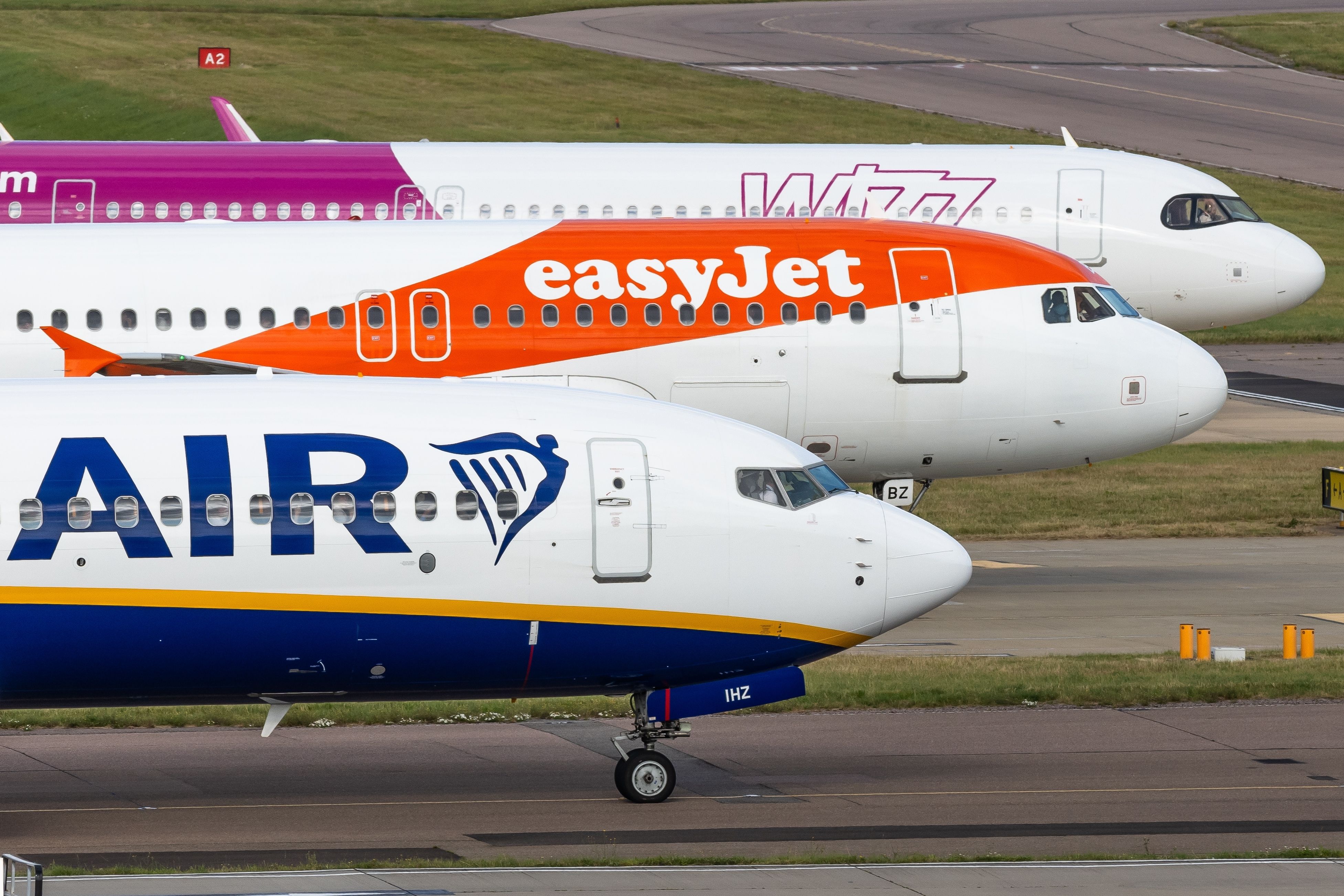 easyJet, Ryanair, and Wizz Air aircraft at London Luton Airport LTN shutterstock_2494460815