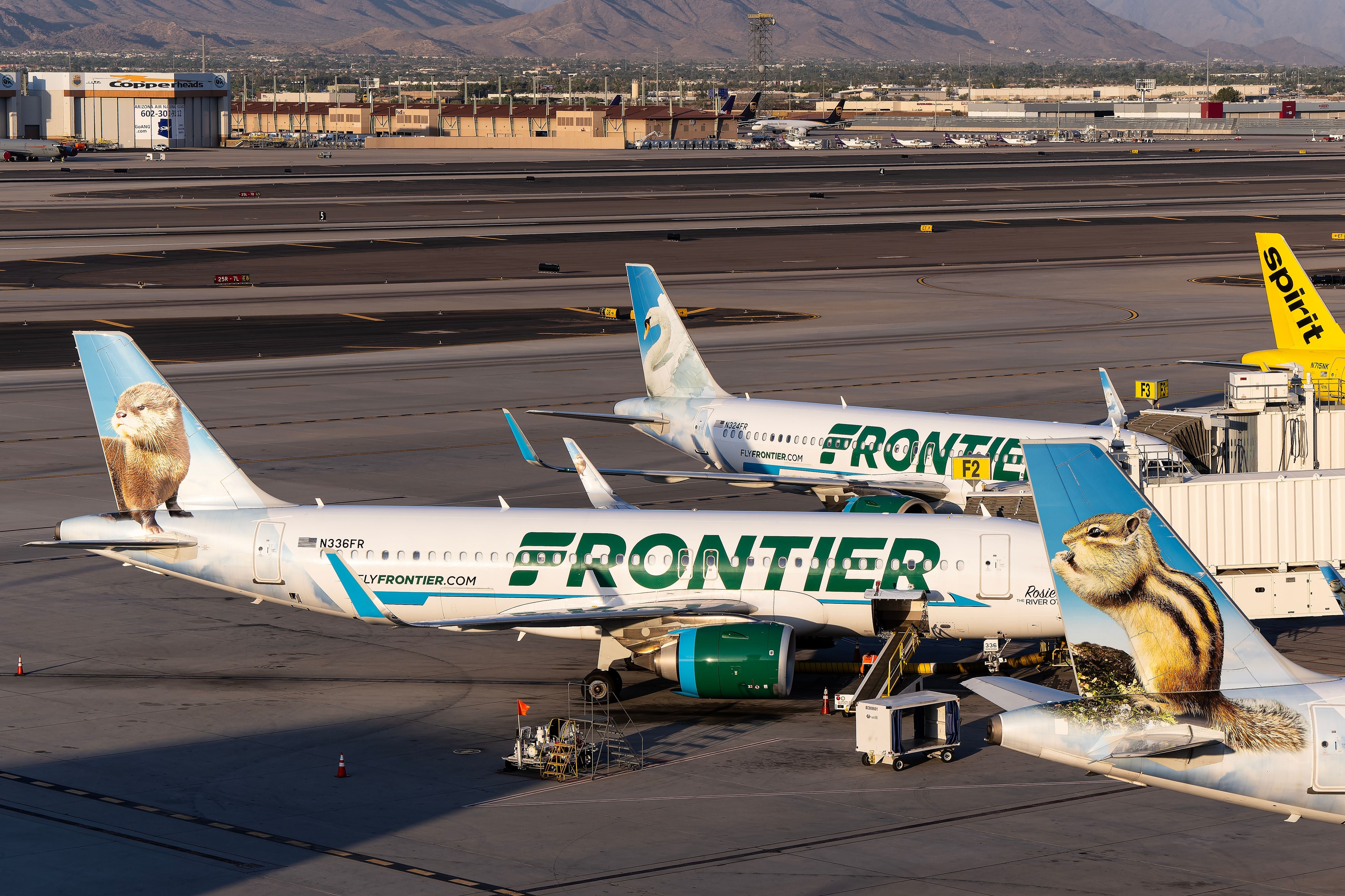 Frontier Airlines and Spirit Airlines aircraft at PHX shutterstock_2476490977