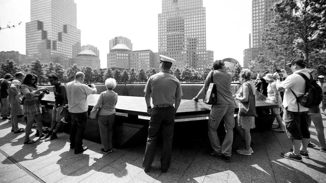 Photo of US Marine standing at the 9:11 memorial